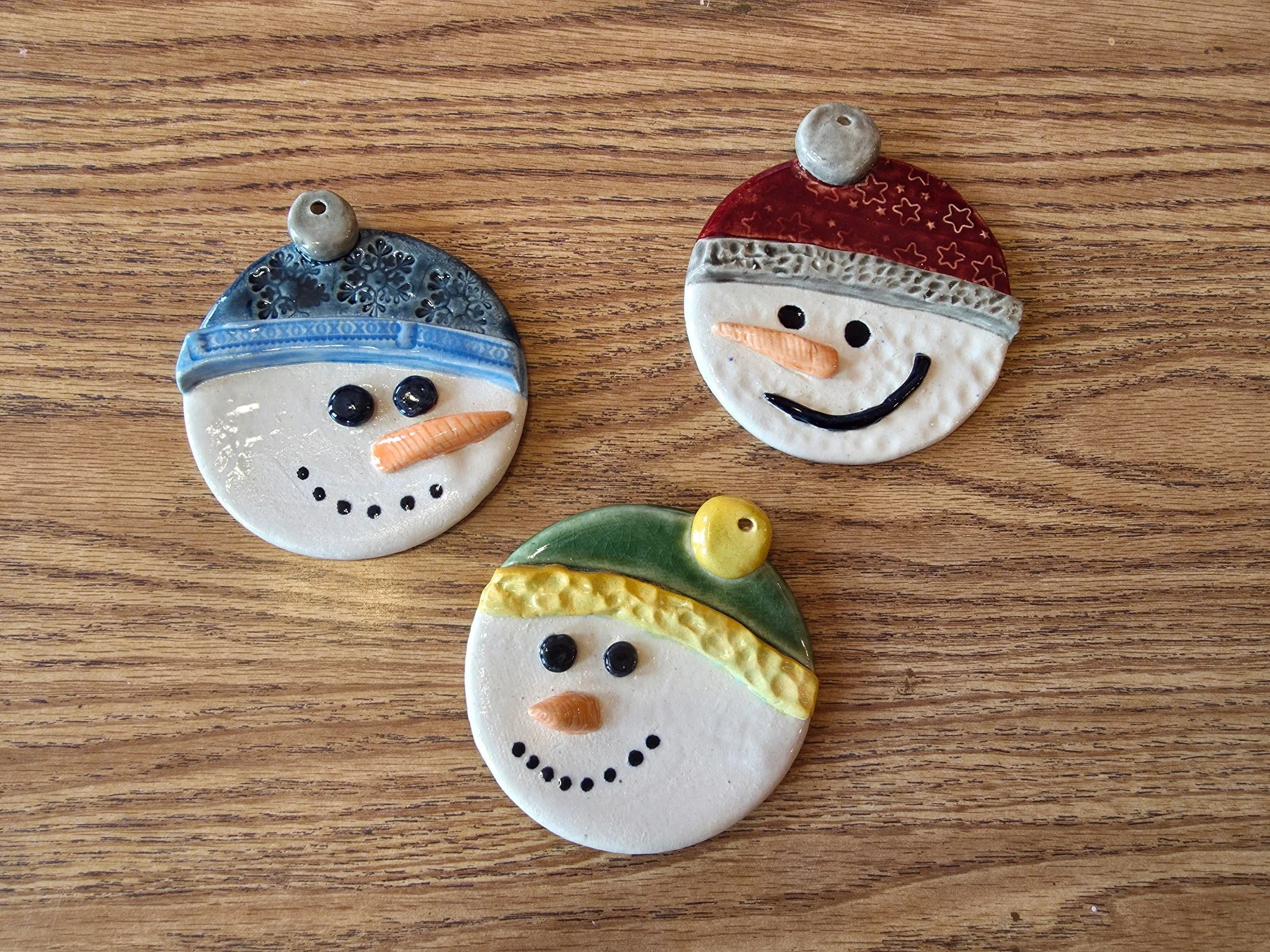 Sample of three ceramic snowman ornaments.