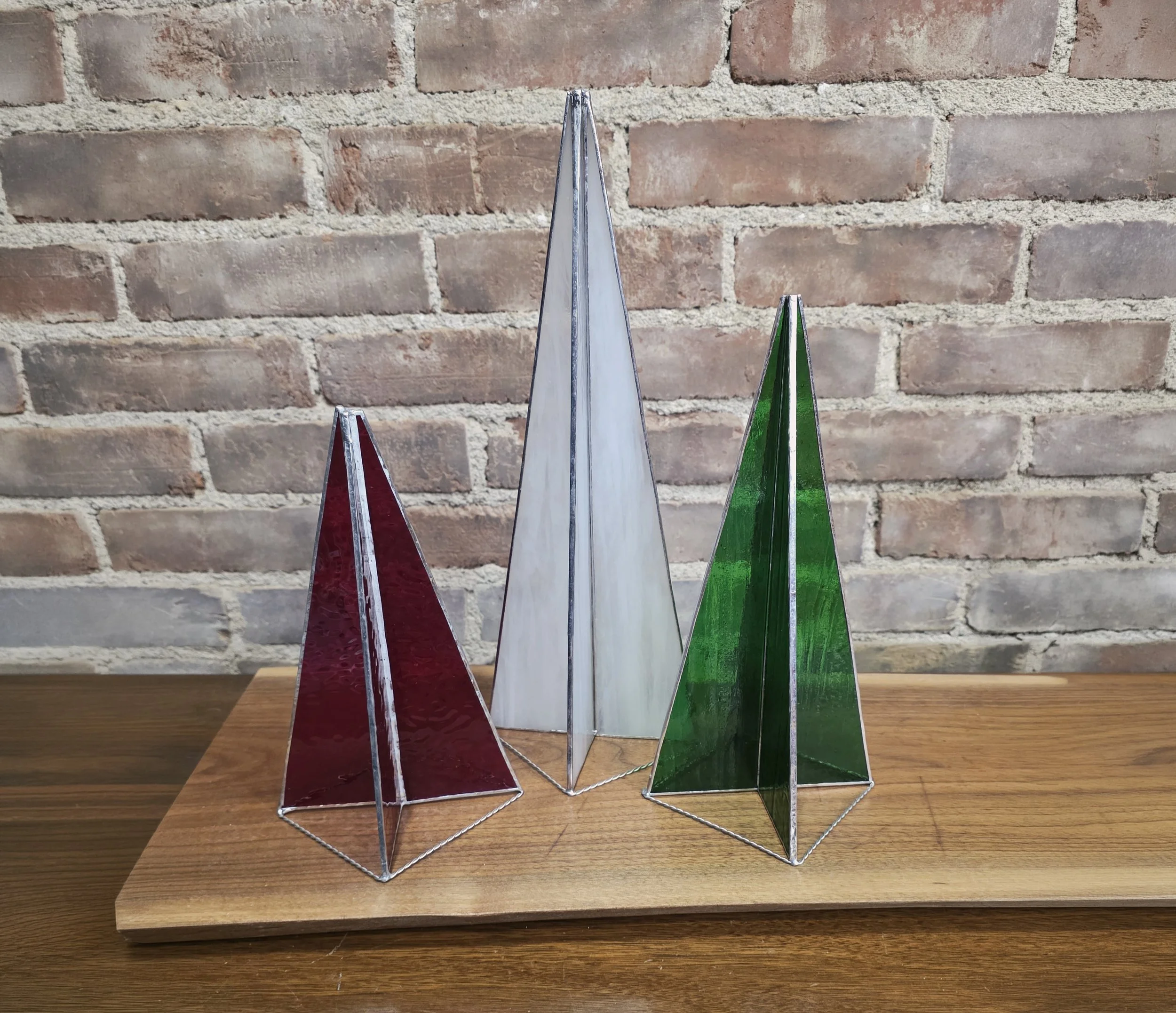 Three stained glass tree spires with red, green, and white frosted glass.