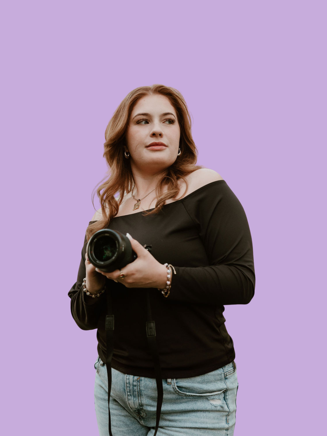 Woman holding a camera against a purple background.