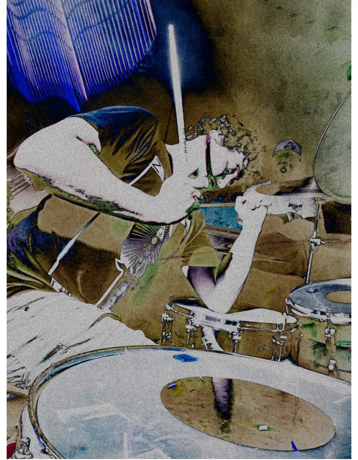 Pierson Whicker of Tampa Bay Psych Rock band Liquid Pennies  playing drums, holding drumsticks, in a room with drums and musical equipment, muting the snare with his elbow.