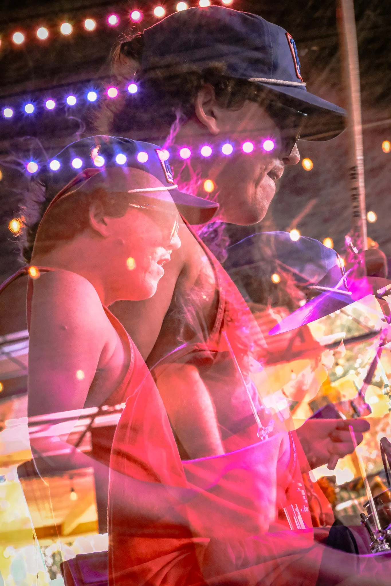 Double-exposed photograph of Liquid Pennies Drummer Pierson Whicker performing at an outdoor concert in Saint Petersburg, Florida.