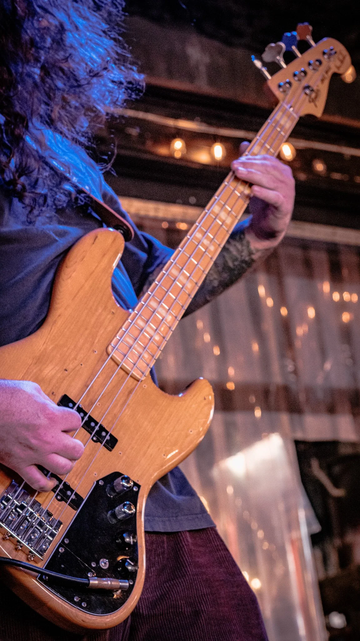 Liquid Pennies bassist Tysonious Mink performing at a live show.