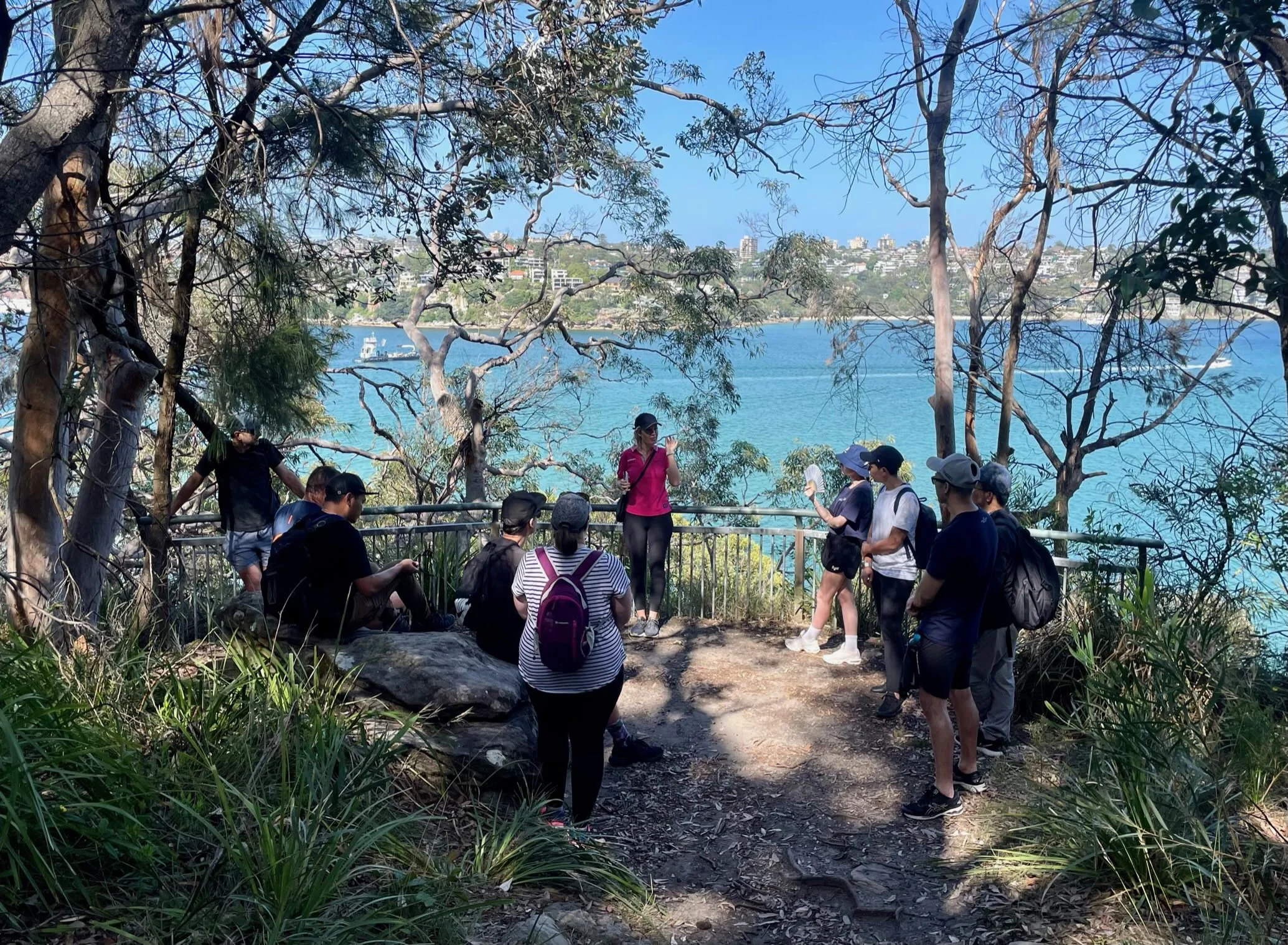 A team gathers at a scenic harbor overlook during a Collective Leadership Lab, participating in an immersive leadership development experience designed to build trust and collaboration.