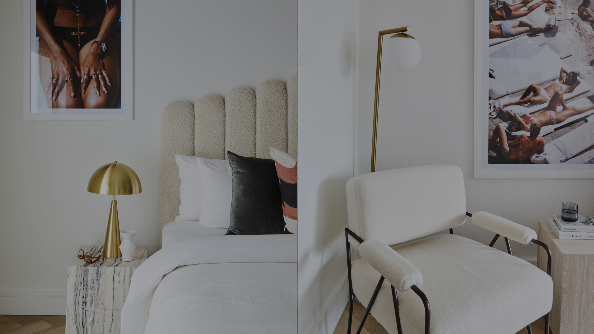 Split view of two different rooms. On the left, a cozy bedroom with white bedding, a beige textured headboard, a gold bedside lamp, and framed photographs on the wall. On the right, a minimalist seating area with a cream armchair, a gold and white fl