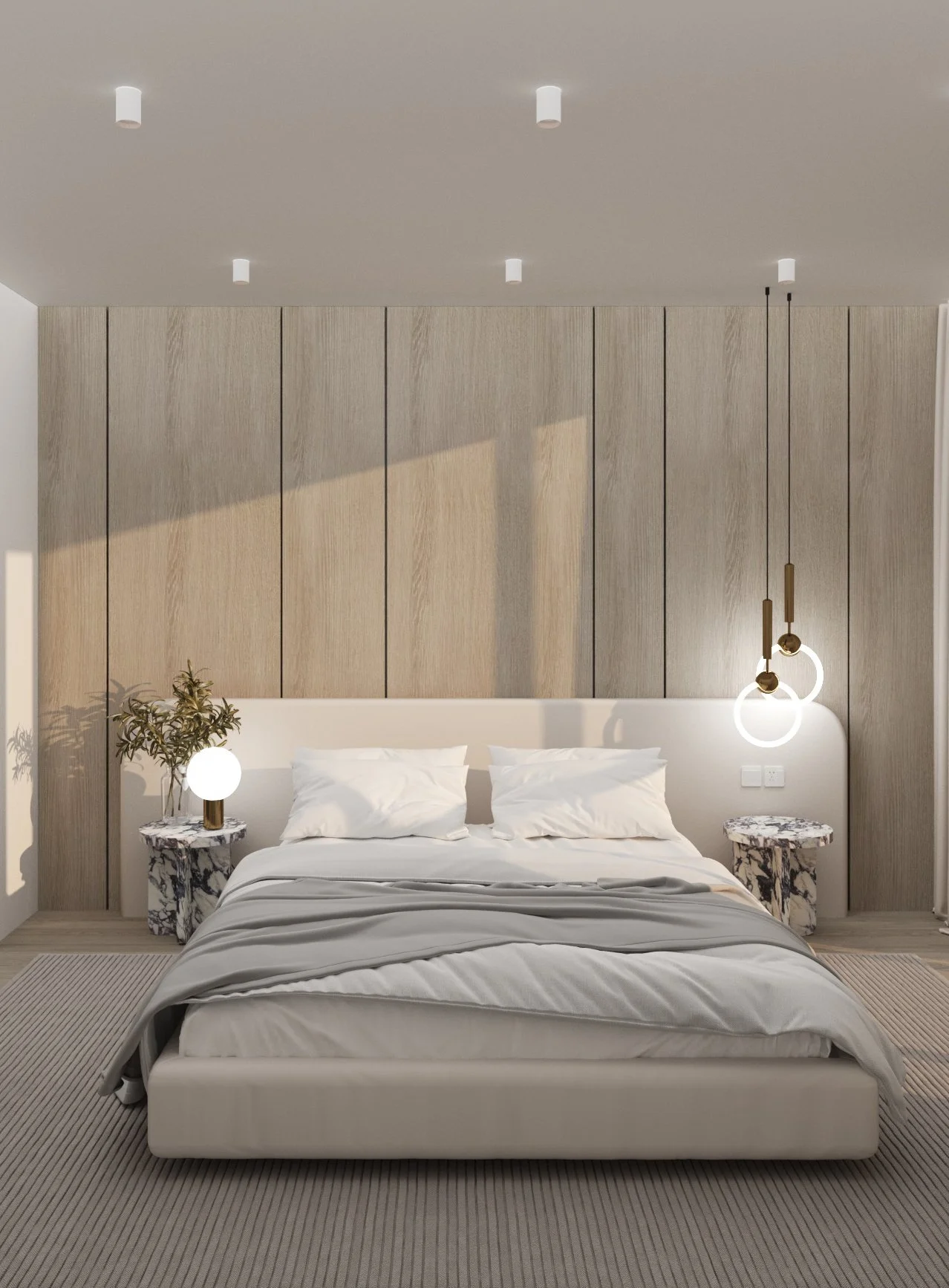 Modern bedroom with a large bed, white bedding, and pillows, flanked by two marble side tables with lamps; wooden paneled wall behind the bed; decorative pendant lights hanging from the ceiling; a plant on the left side.