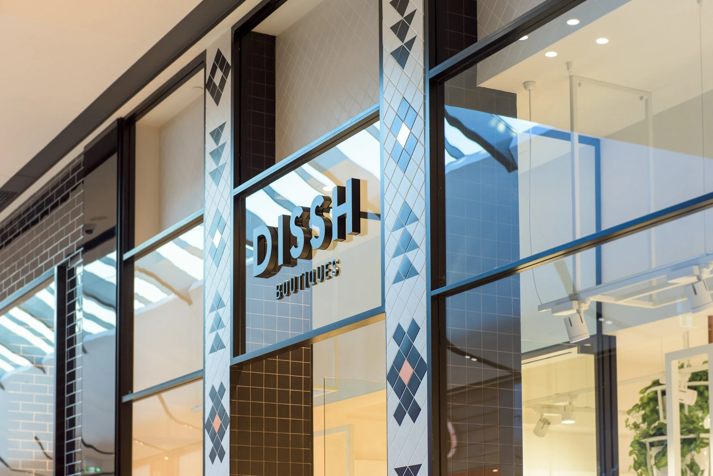 A storefront with large glass windows and a sign that reads 'DISS