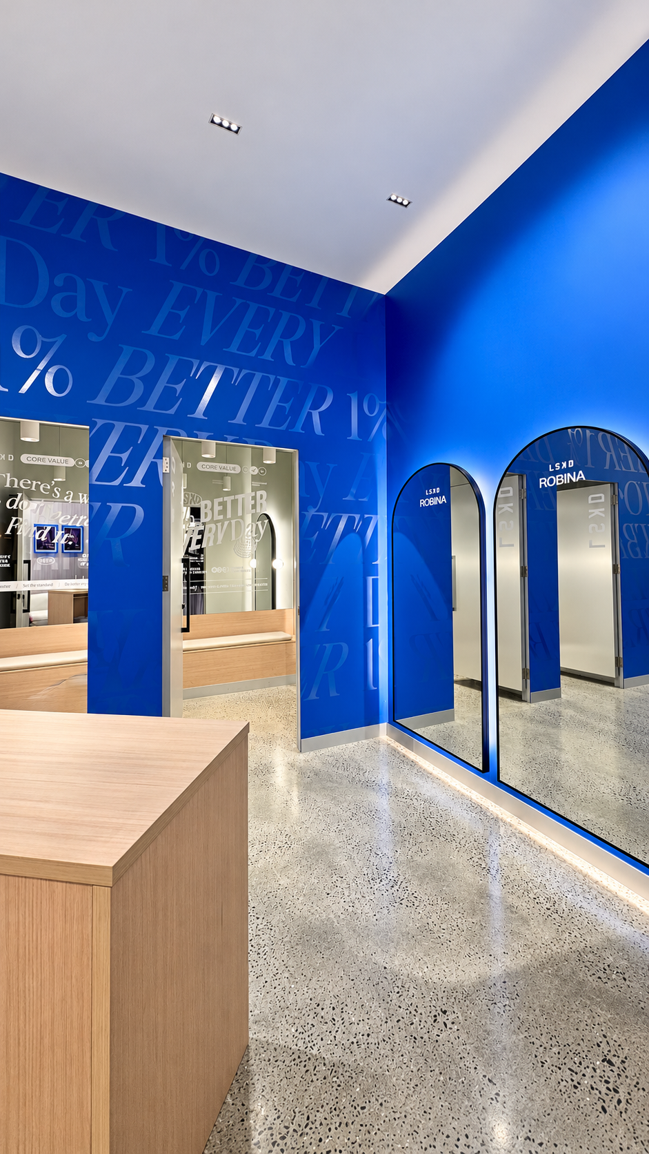 Arched fitting-room mirrors and an oak counter within LSKD Robina.