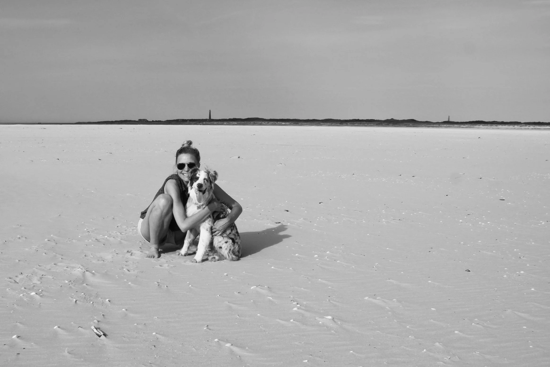 Robien knuffelt haar hond op het strand van Schiermonnikoog.