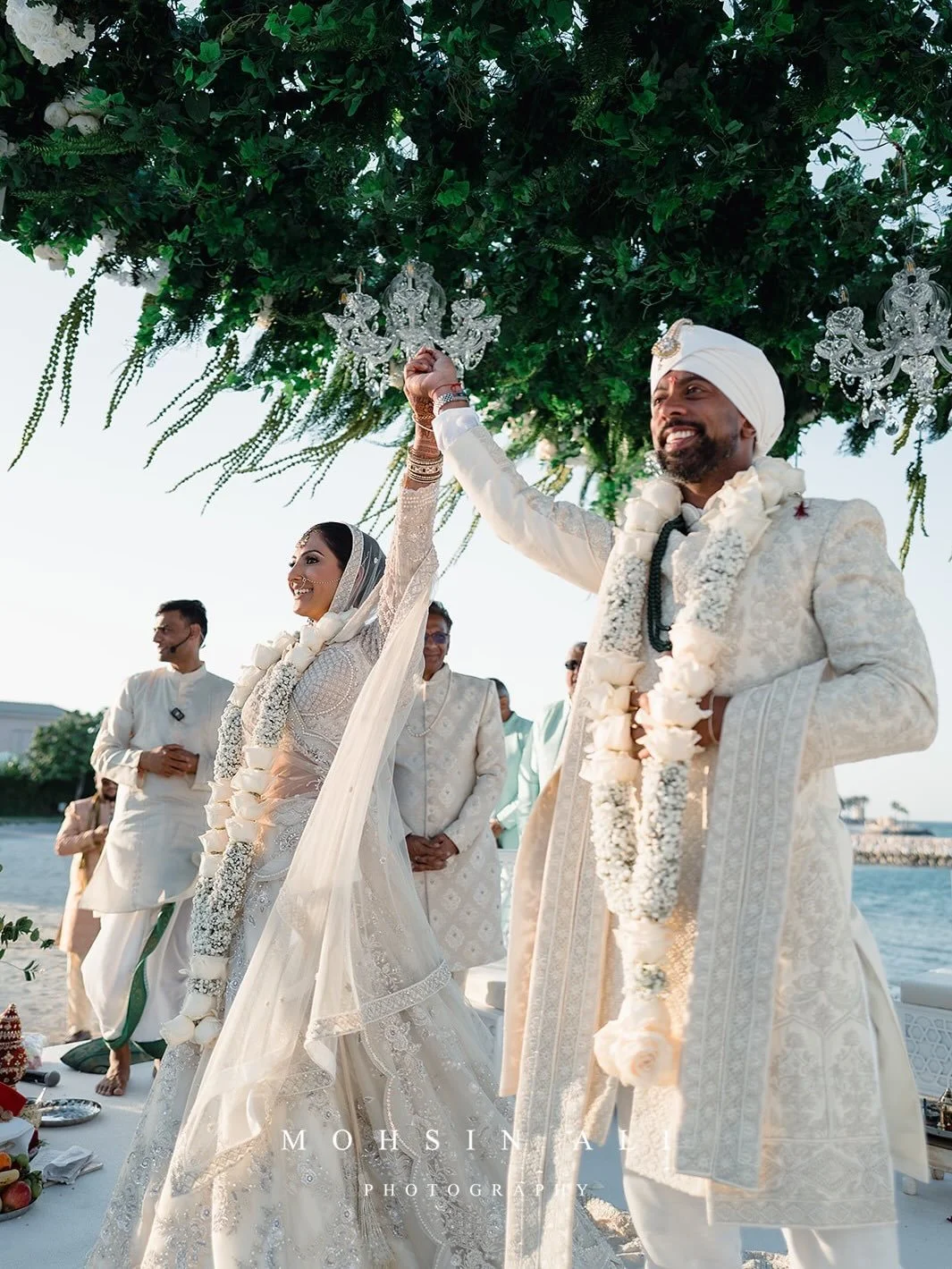A sunset wedding ceremony set against the sea..
Soft white florals with layered greens, a neutral palette designed to complement the beautiful Bahrain backdrop ✨

Destination Wedding Planner @_pristineevents_ 
Photo - @mohsinaliphotography
AV &amp; P