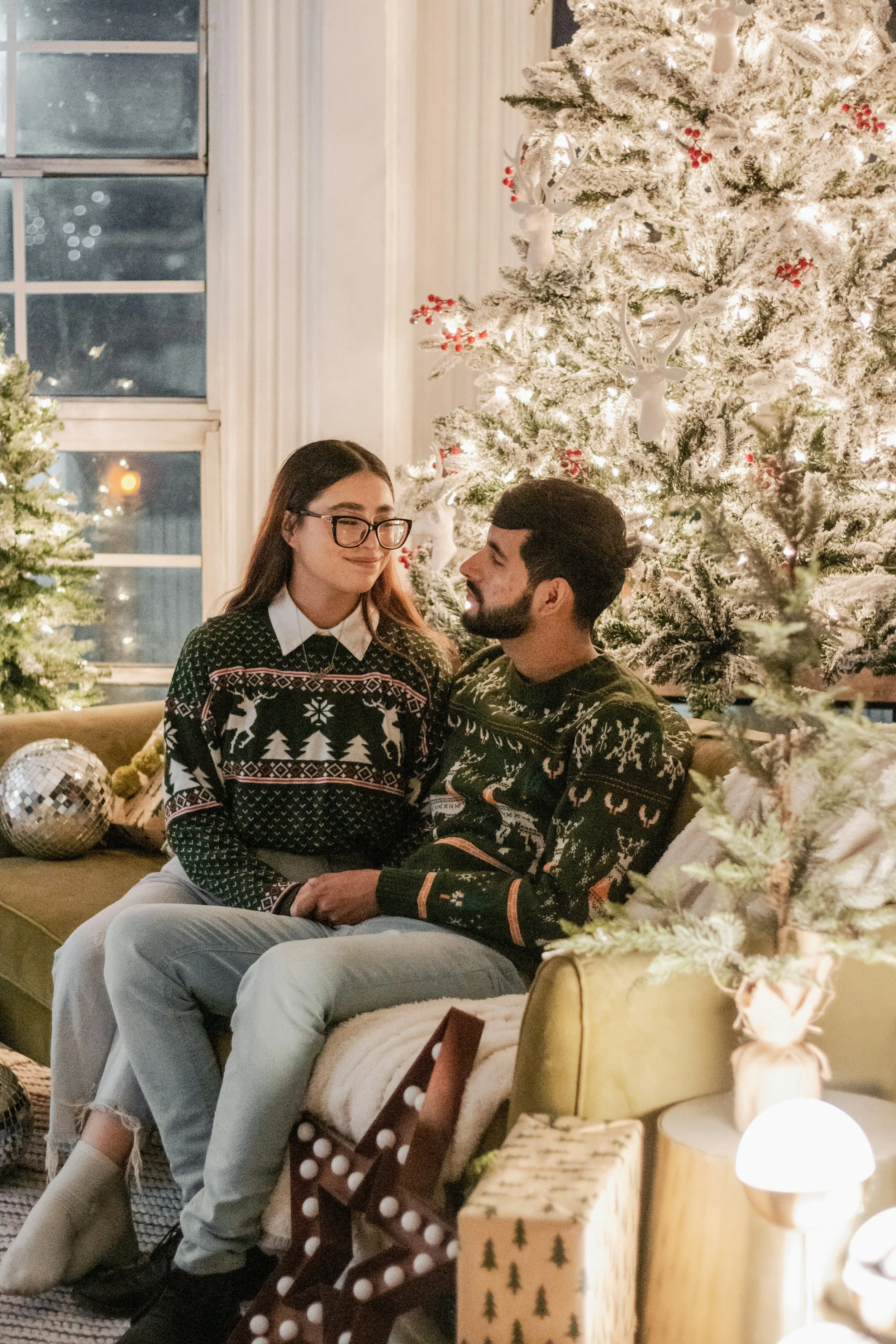 couple embracing in front of Christmas after couples counseling at lovers counseling in Boulder, CO.