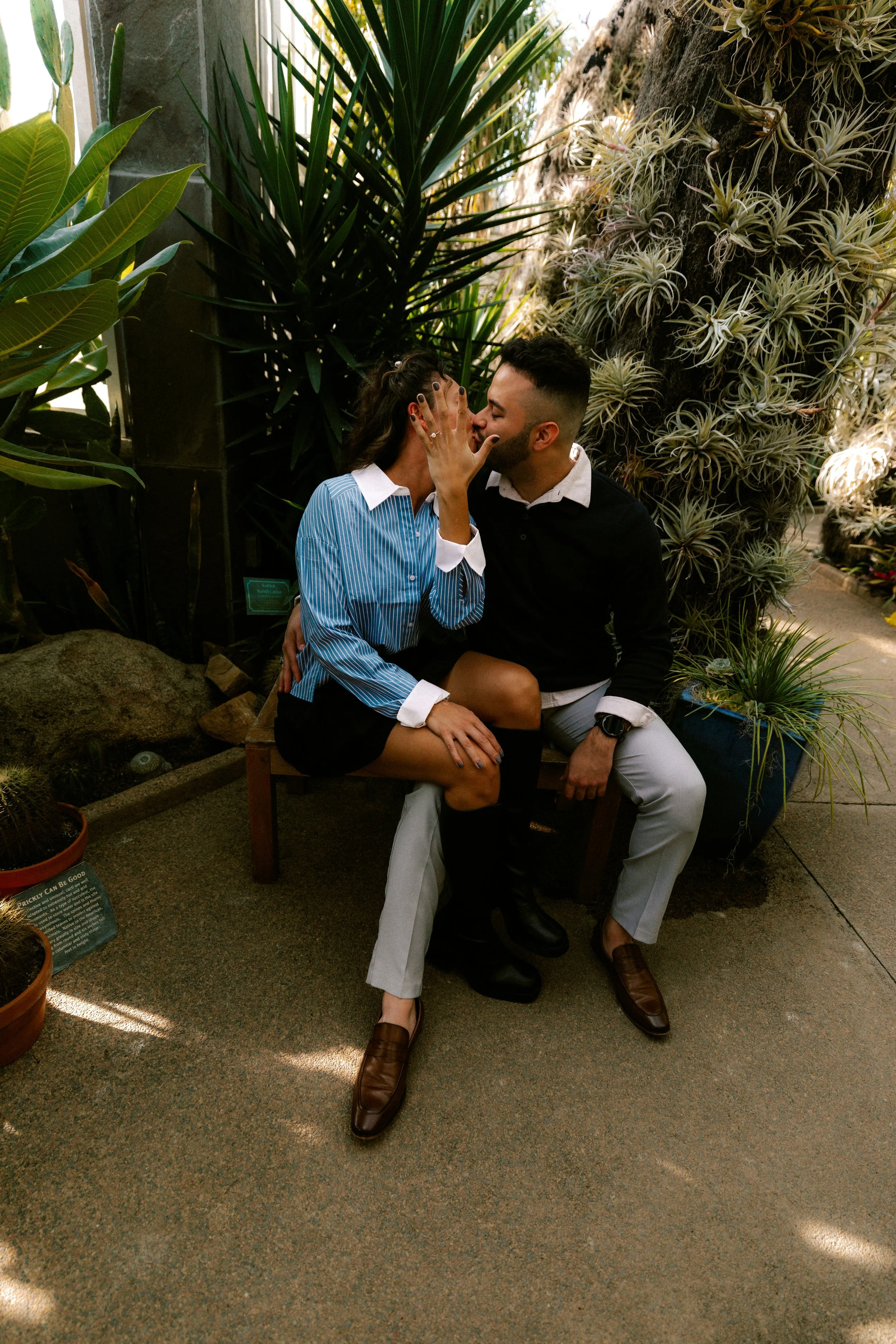 A couple walking hand in hand through a greenhouse filled with greenery, representing emotional growth and communication in premarital therapy in Boulder, CO.