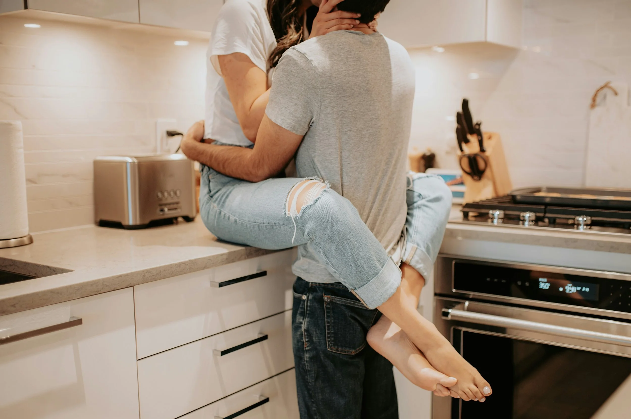 Two partners embracing after couples counseling session, embodying relational repair and prevention.