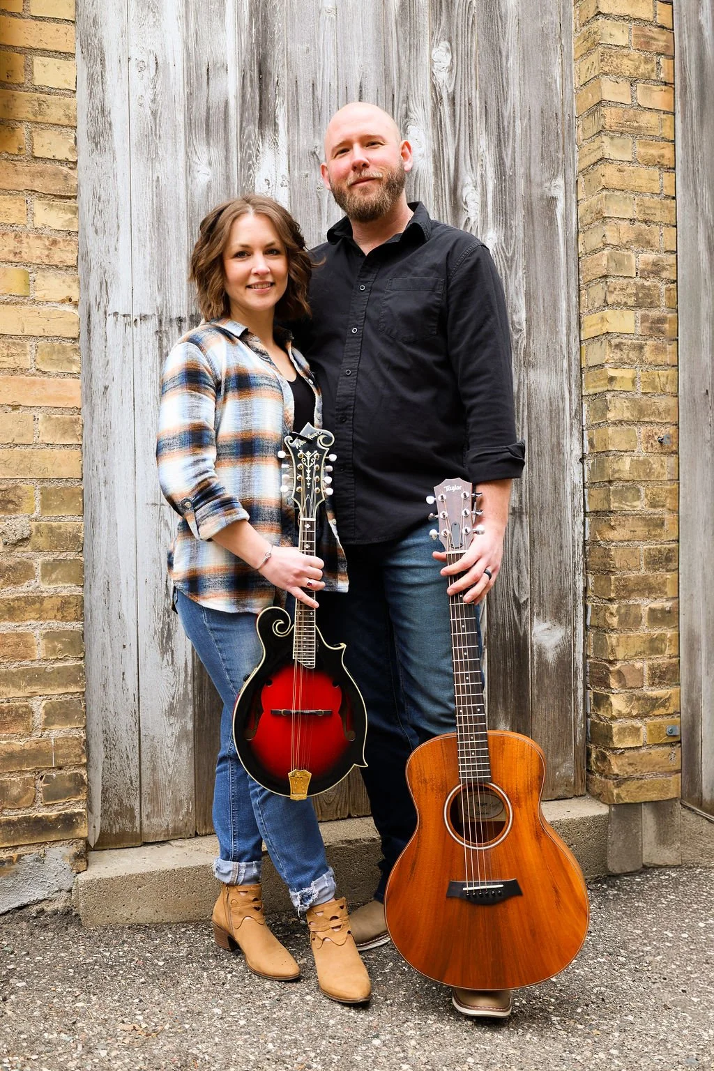 Ray and Kayla Noble with a mandolin and an acoustic guitar.