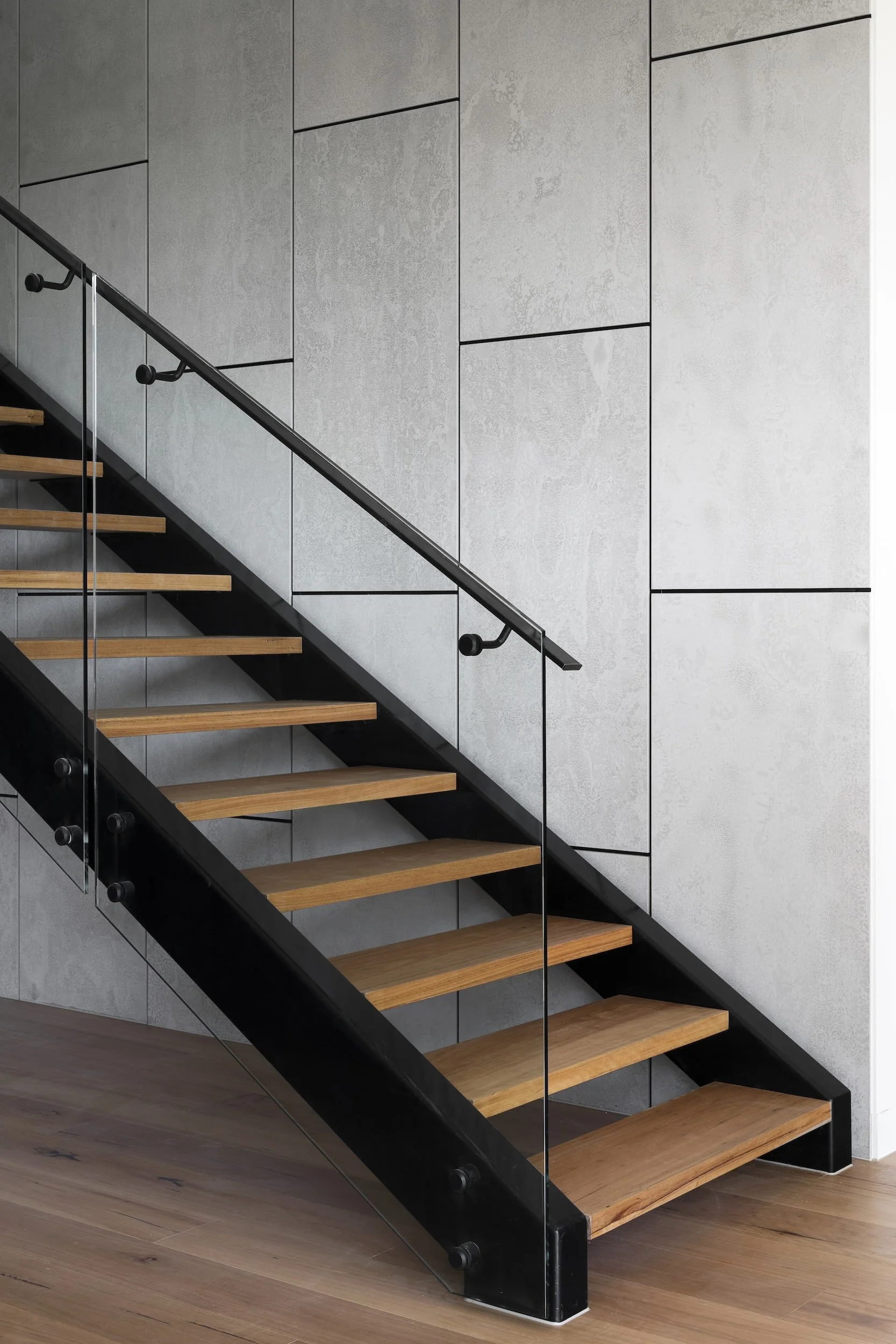 Stunning modern staircase in custom home - Lighthaus Built