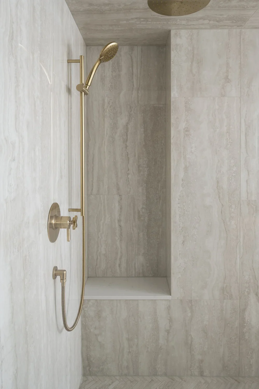 Natural stone shower for spa like bathroom in a Bloor West Condo renovation by Lighthaus Built.