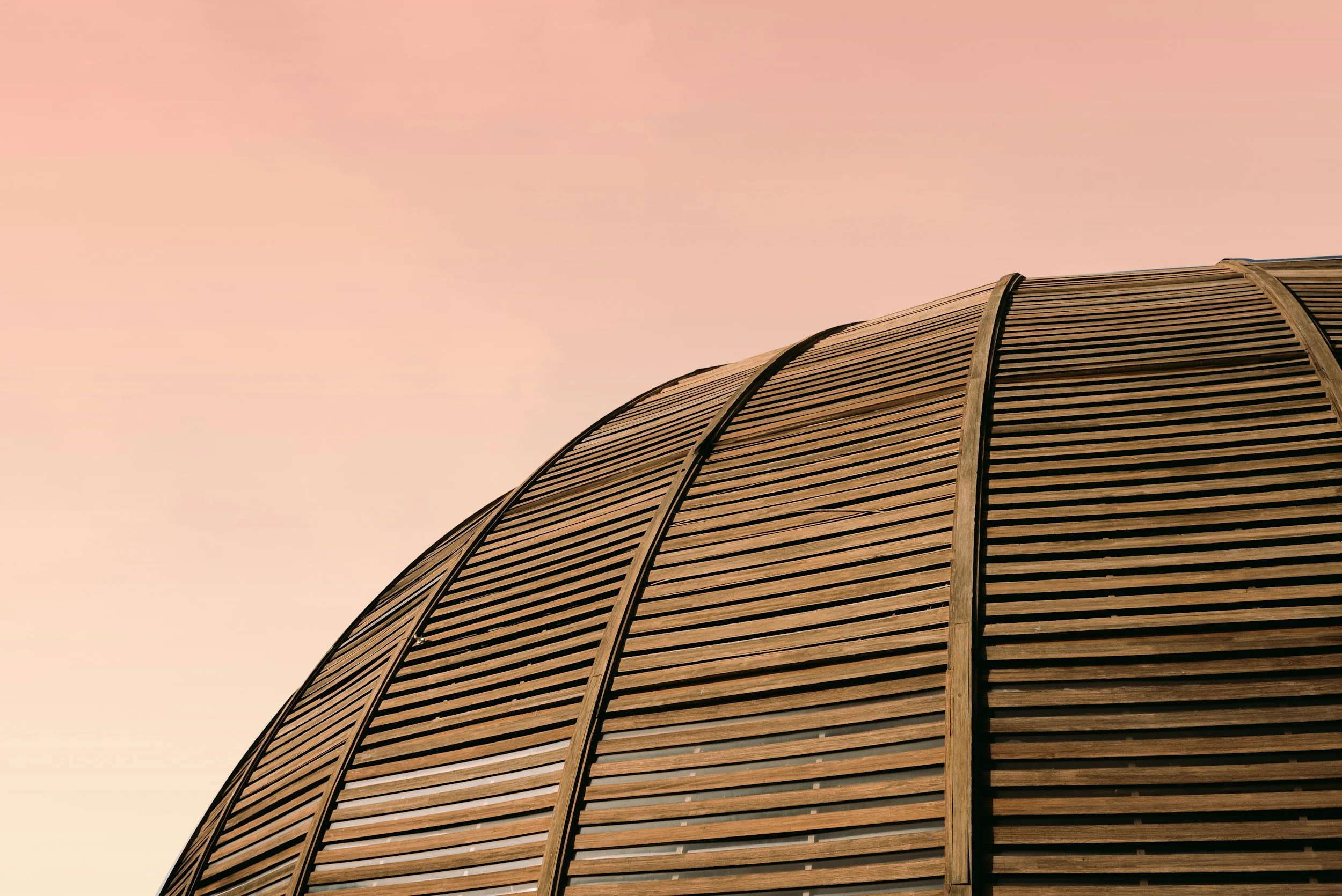 Architectural detail of the timber and glass roof of the UniCredit Pavilion in Milan, Italy, showcasing sustainable structural design and natural light integration.