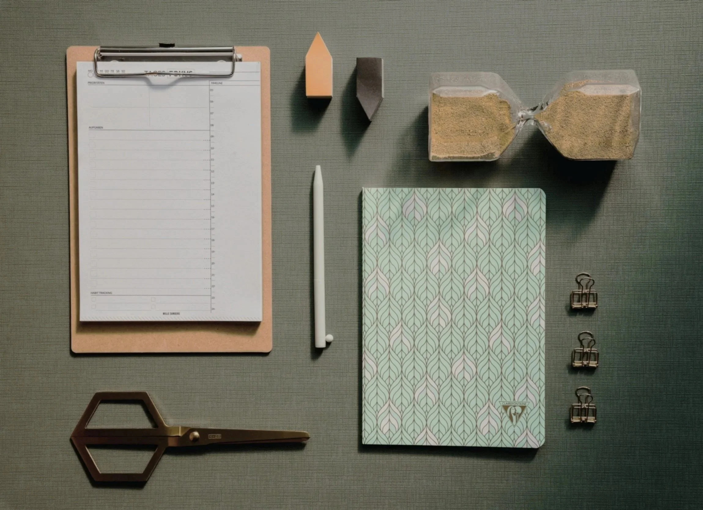 Items laid out on a desk in a perpendicular fashion representing the orderly nature of GRI and CDP reporting.