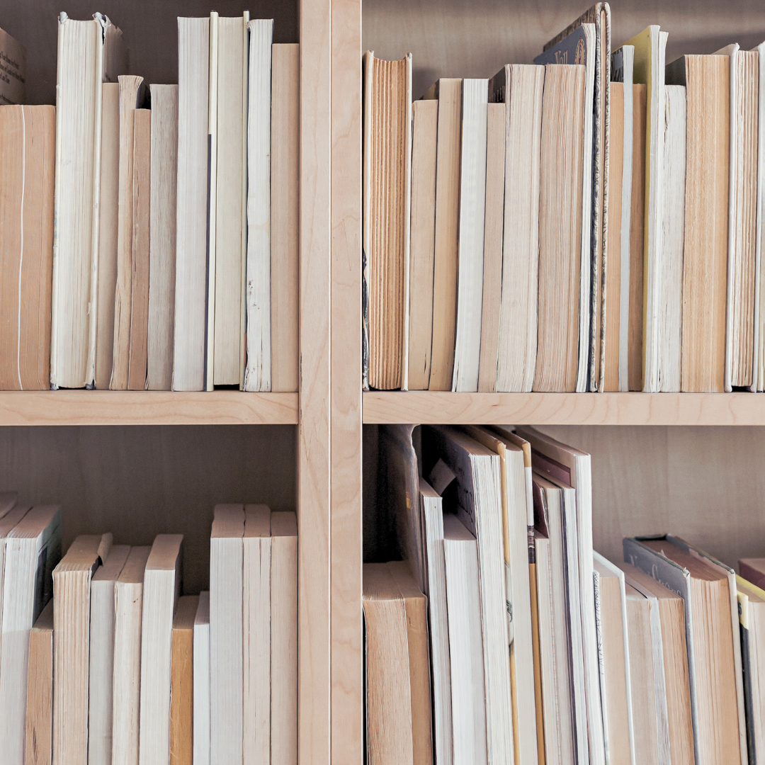Wooden bookshelf filled with a large collection of books.