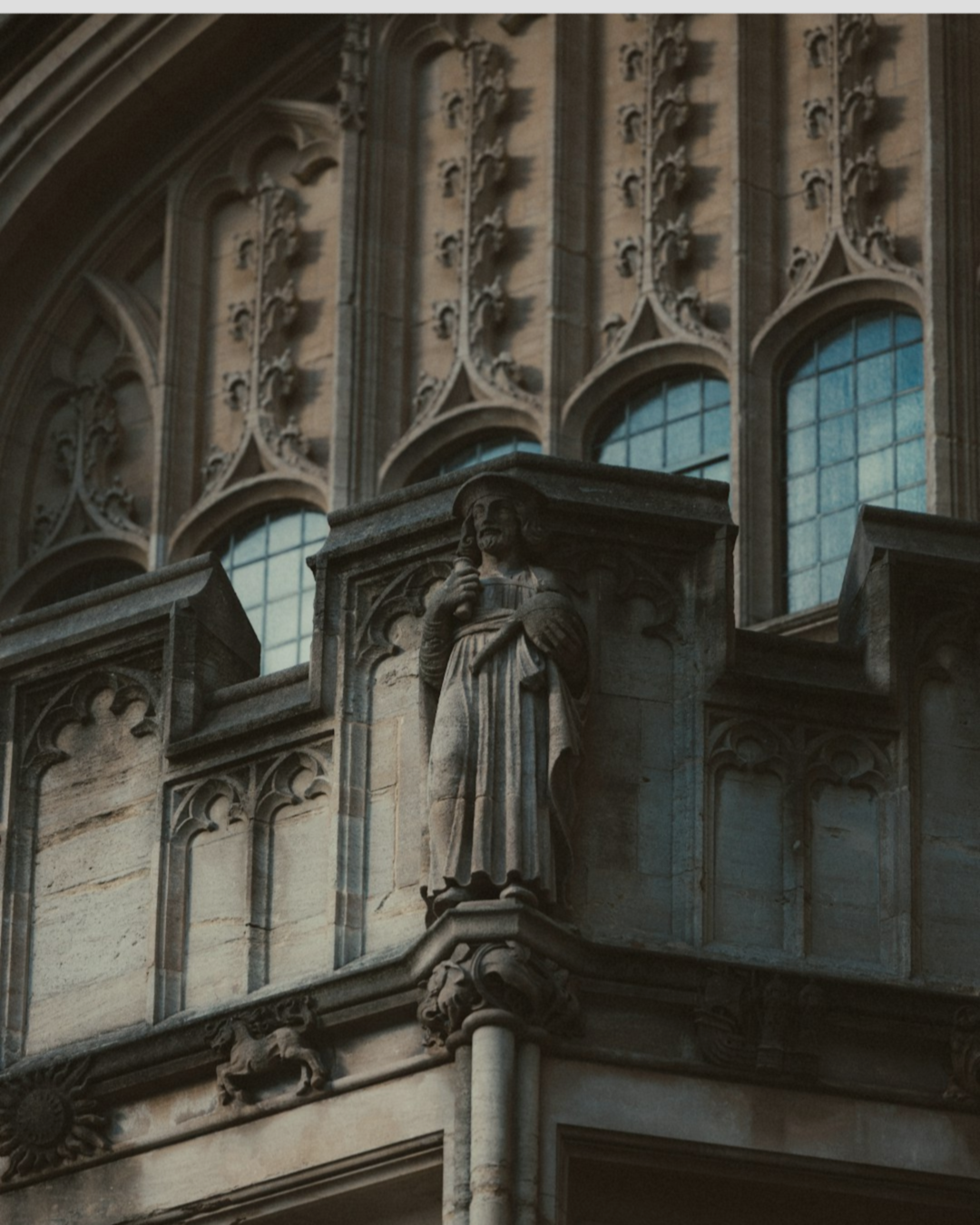 Figure carved into gothic cathedral, holding a scroll. This represents the Uncovery part of the Bold Green Strategies method.