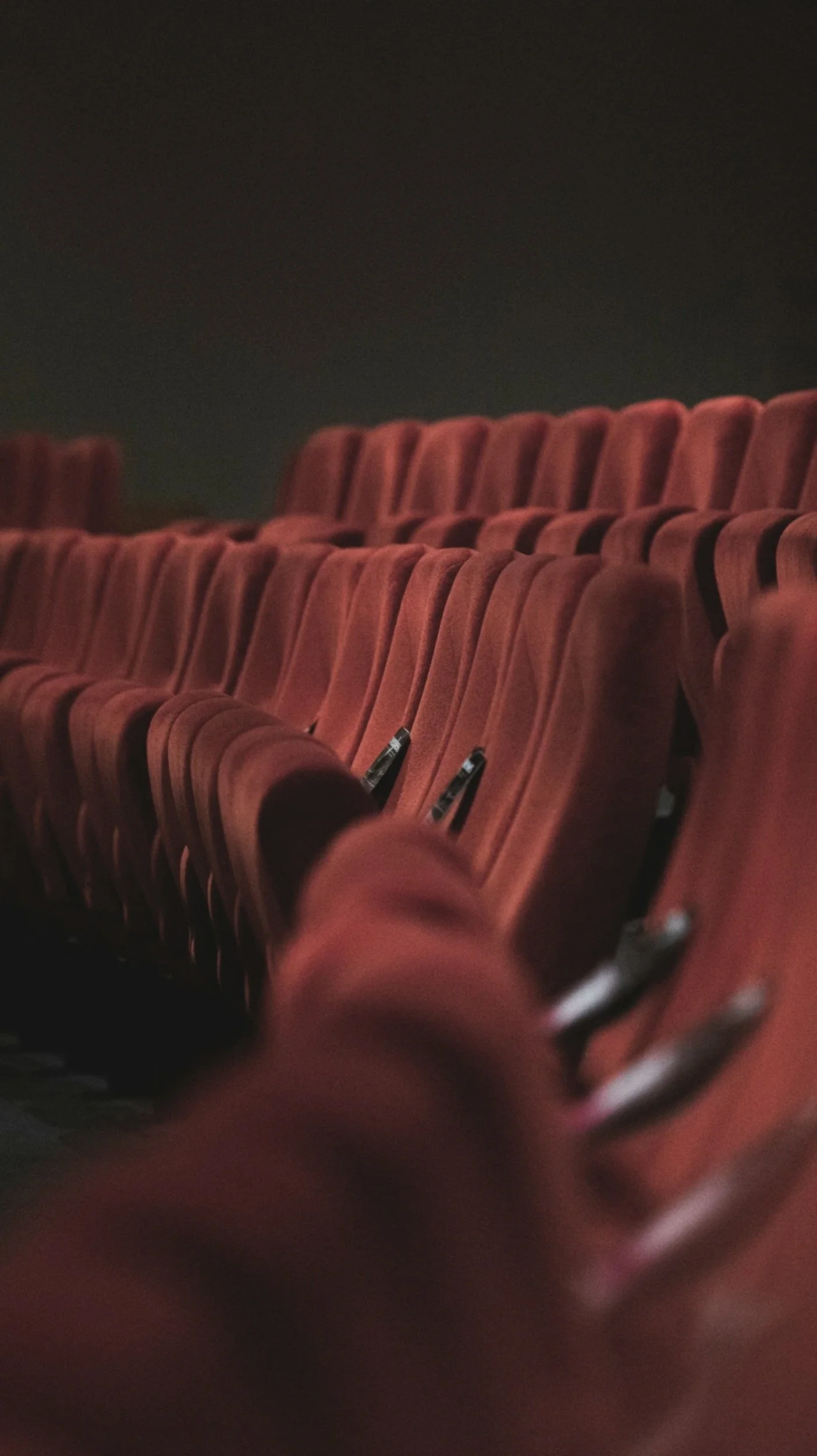 Red cinema seats representing the conultancy's work in the culturte, arts and heritage sectors.