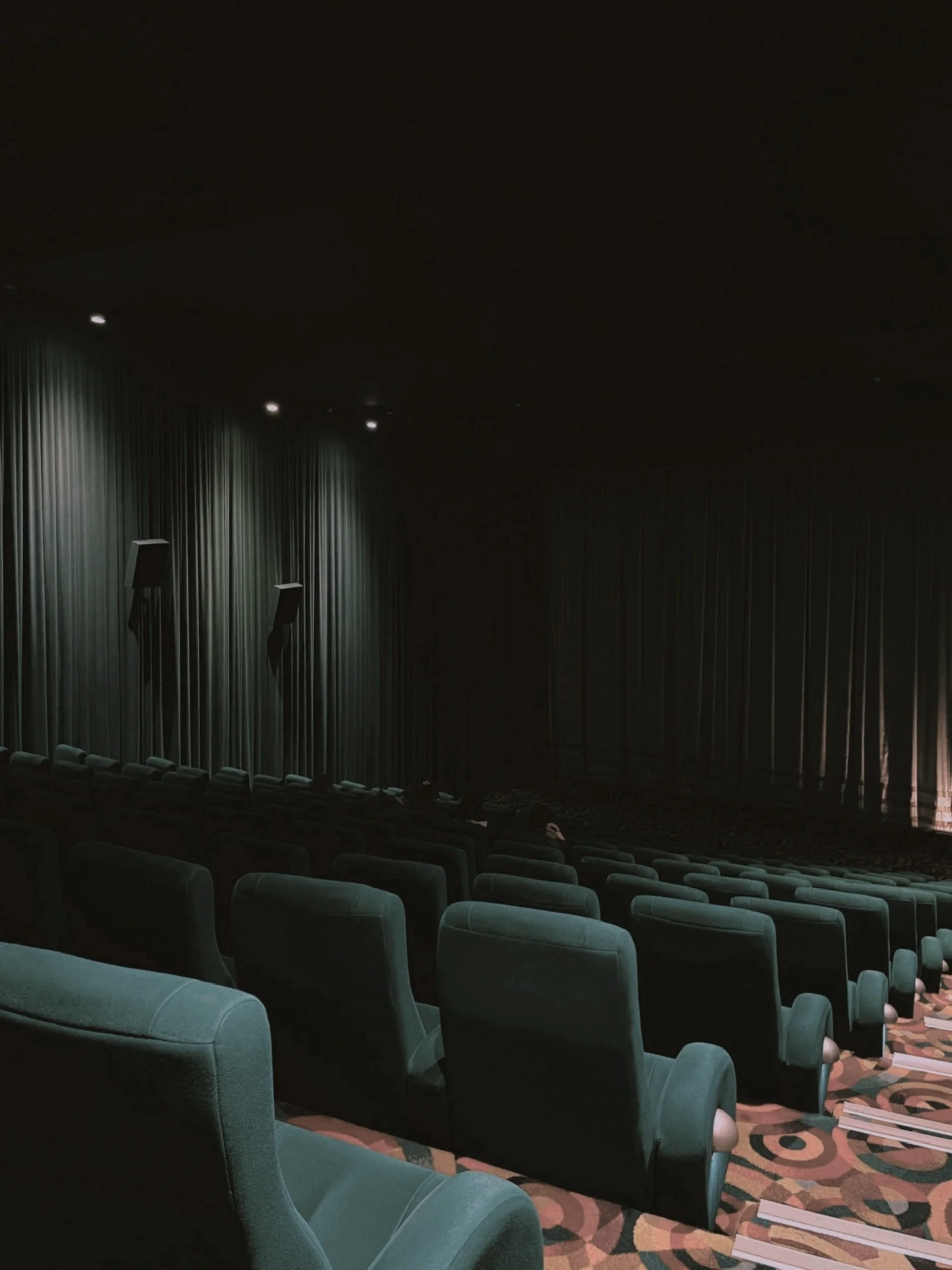 Green seats in a cinema or theatre representing the audience and readers of the case studies and impact reports worked on for luxury events, awards ceremonies, and B Corp clients.