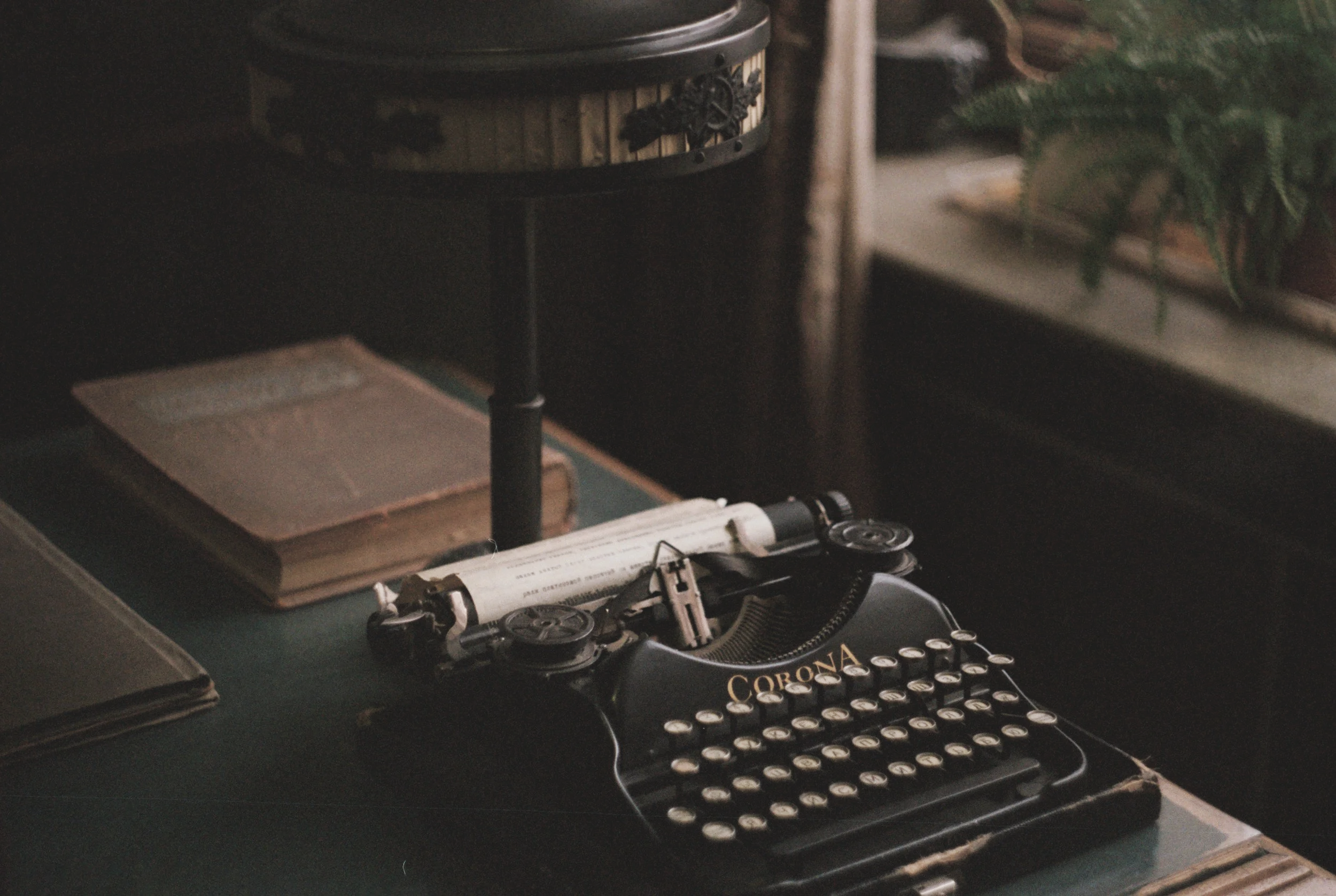 Old typewriter on a desk with a lamp representing Harker carbon footprinting tool.