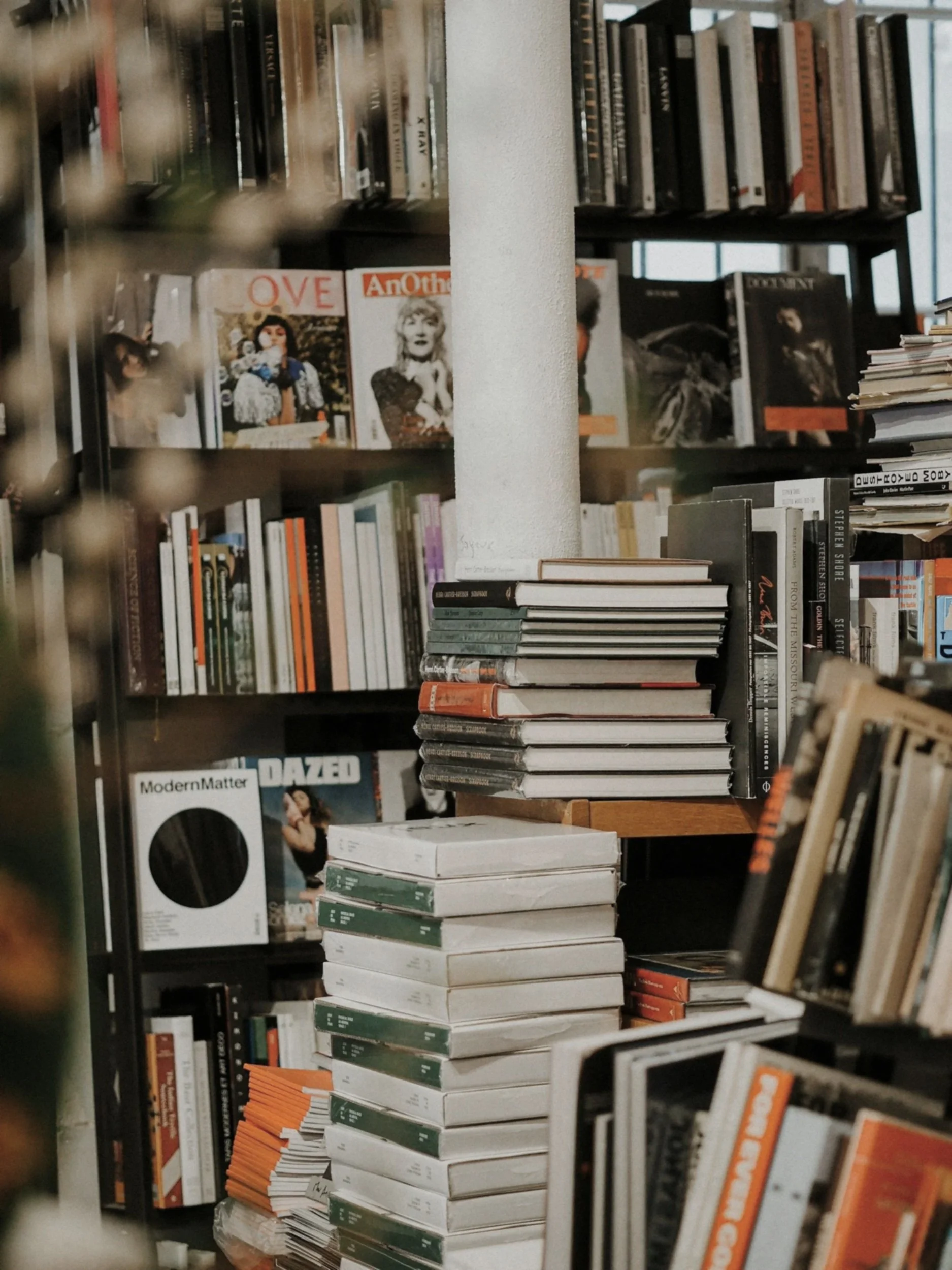 Books and magazine in a bookshop representing institutional commercial spaces and museum giftshops. This reflects the retail and supply chain scope 3 work the consultancy does.