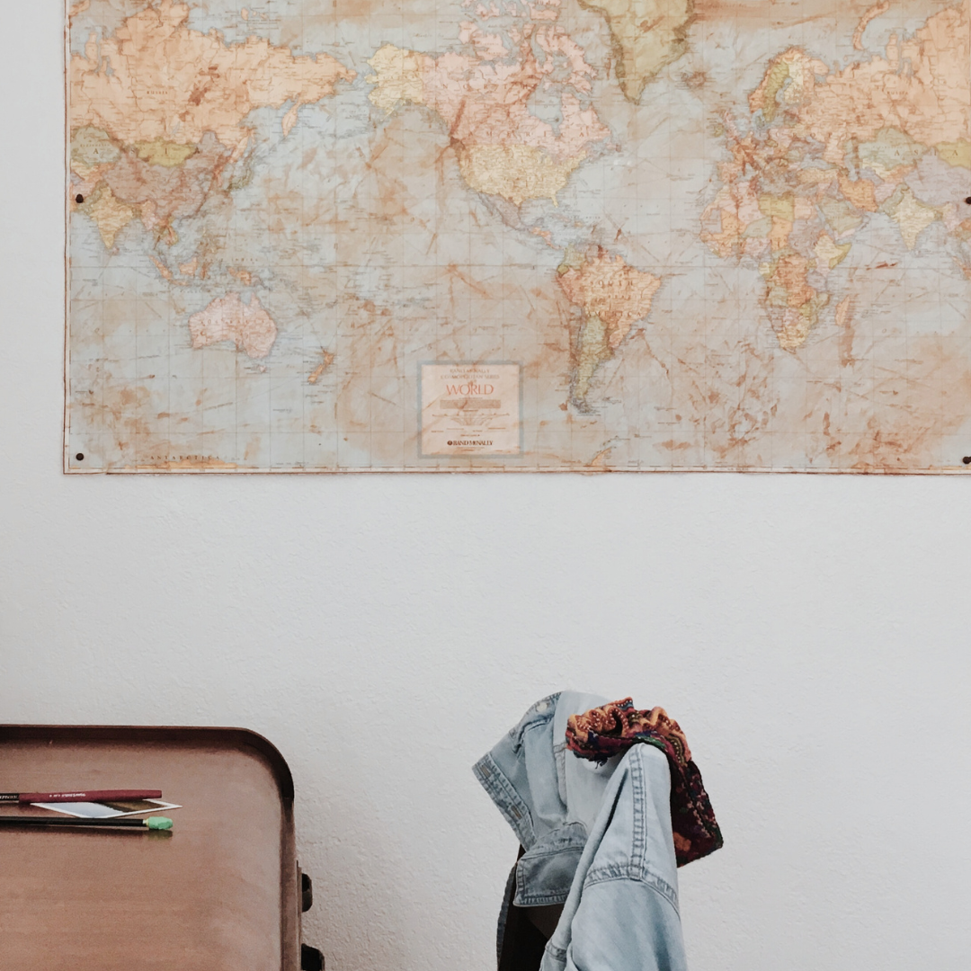 A desk with a world map on the wall. This image is in the Fractional Sustainability Leadership block.