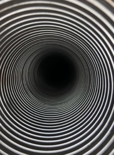 A black and white spiral tunnel with concentric circles creating an optical illusion.