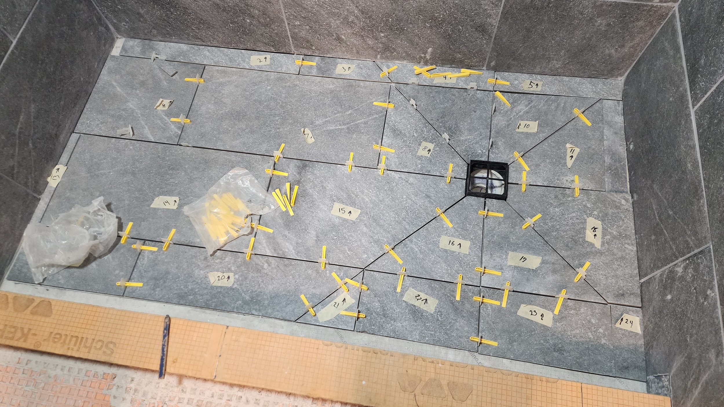 replaced old tub with new large-format tile using Schluter waterproofing system