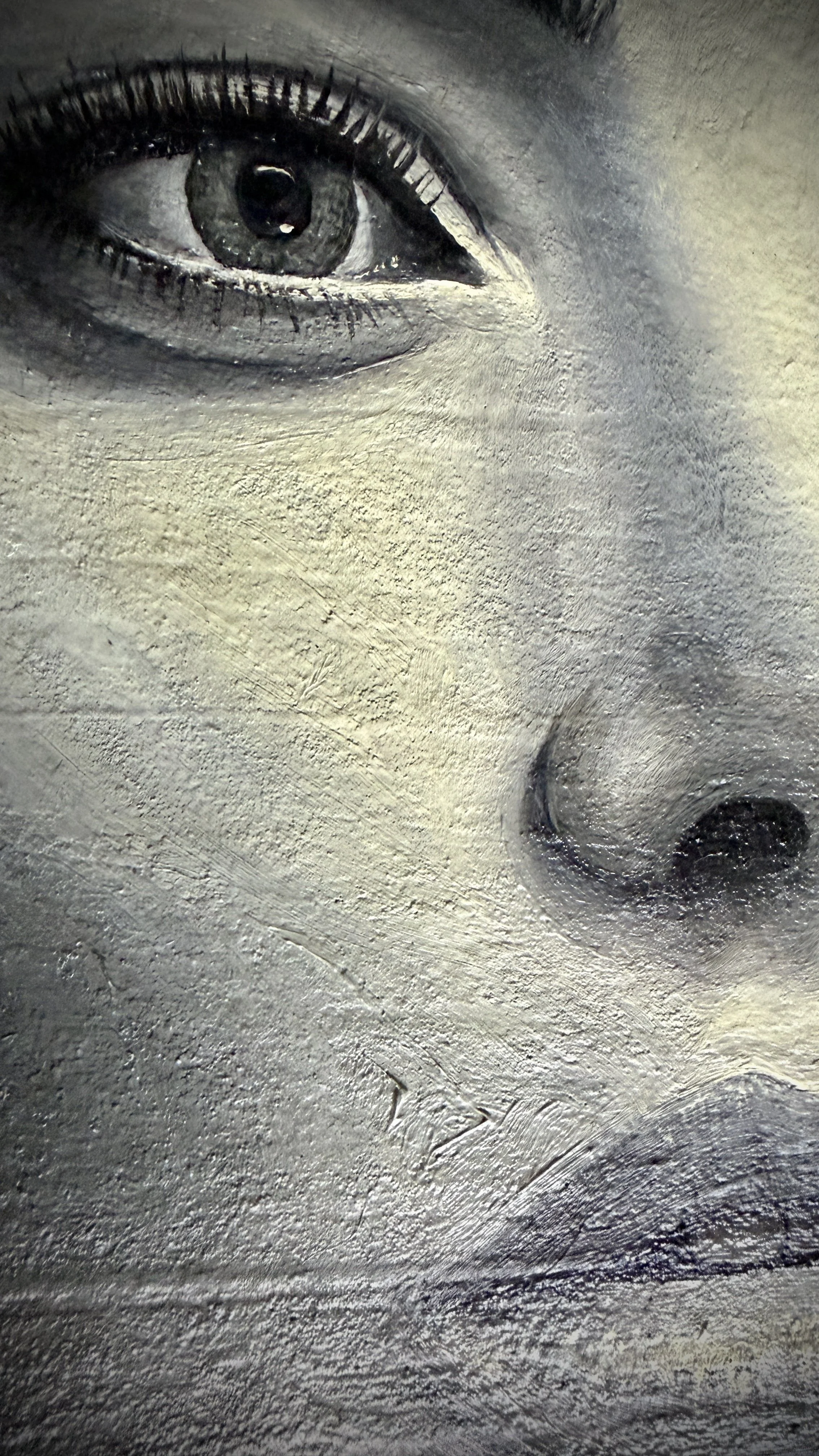 She watches something slipping away, like a dream. Butterflies rest in her hair, fragile and alive against her reserved manner, signs of a still warm and fluttering spirit.