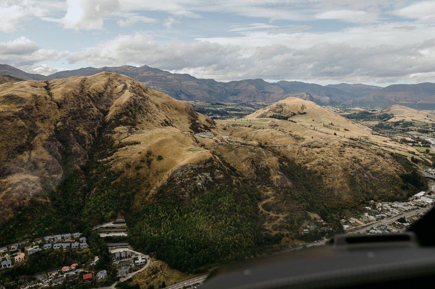 Can you spot us? Located between the two peaks of Queenstown hill, you might see a little white marquee snuggled into the hillside. That's our Lake June marquee, and if you look closely you'll also see the famous Tussock Point too. ⁠
⁠
And, just on t