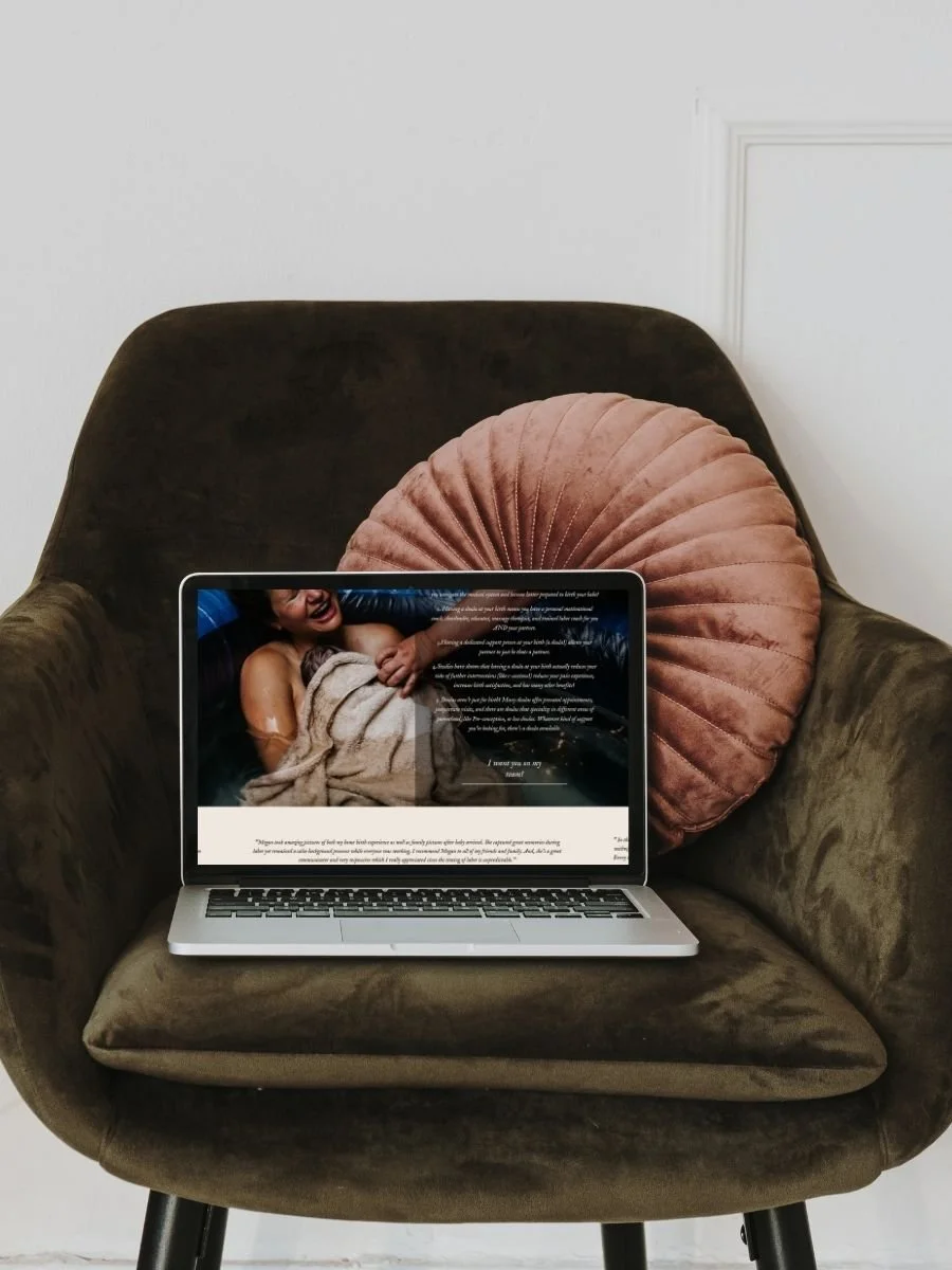 website open on laptop on green chair