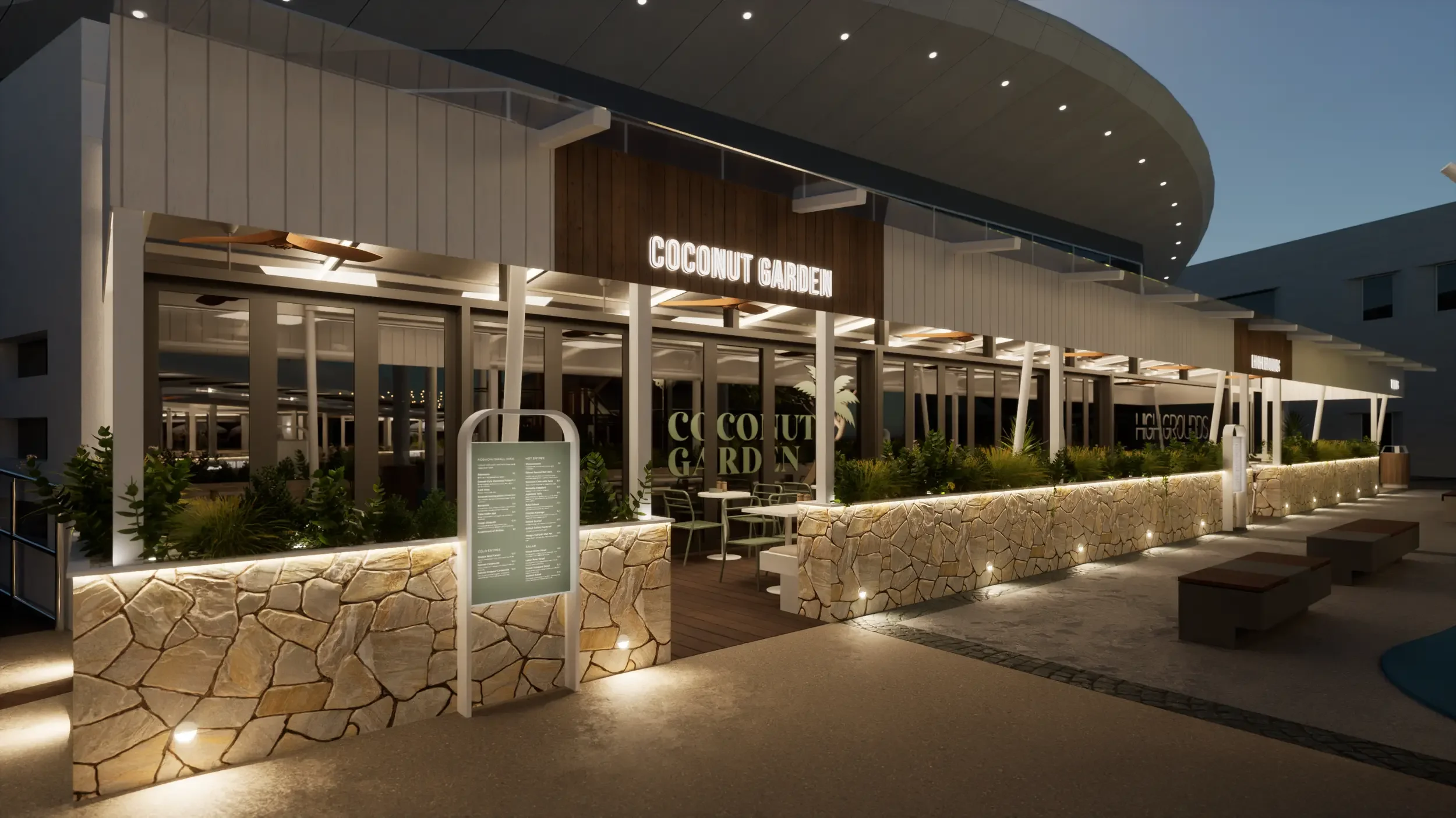 Night view of the exterior of a restaurant called Coconut Garden with modern architecture, glass walls, outdoor seating, and illuminated signage.