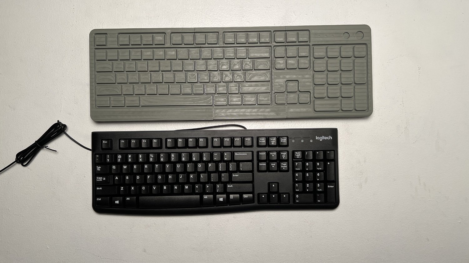 I ultimately settled on combination of key sizes to solve the issue. Discussing further with the audience brought to light that they usually only continue wearing gloves to quickly punch numbers. Any sustained typing is simply easier with the gloves