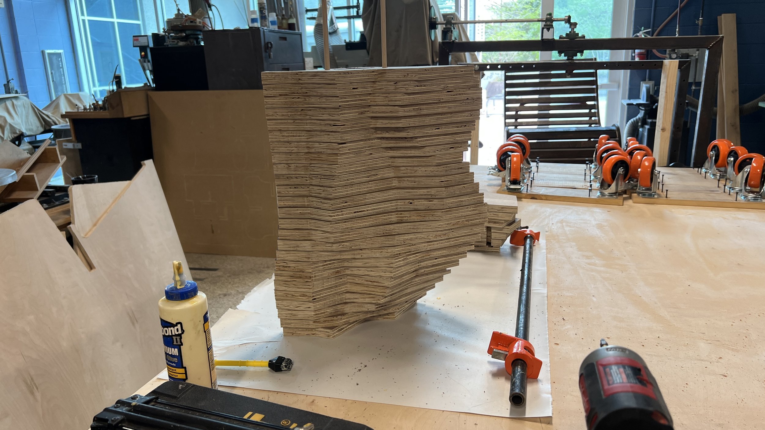 Here are images of the shelf during the final gluing and stacking. A nail gun was used during the gluing process to ensure enough pressure was applied to all of the pieces due to the overhangs in the design.