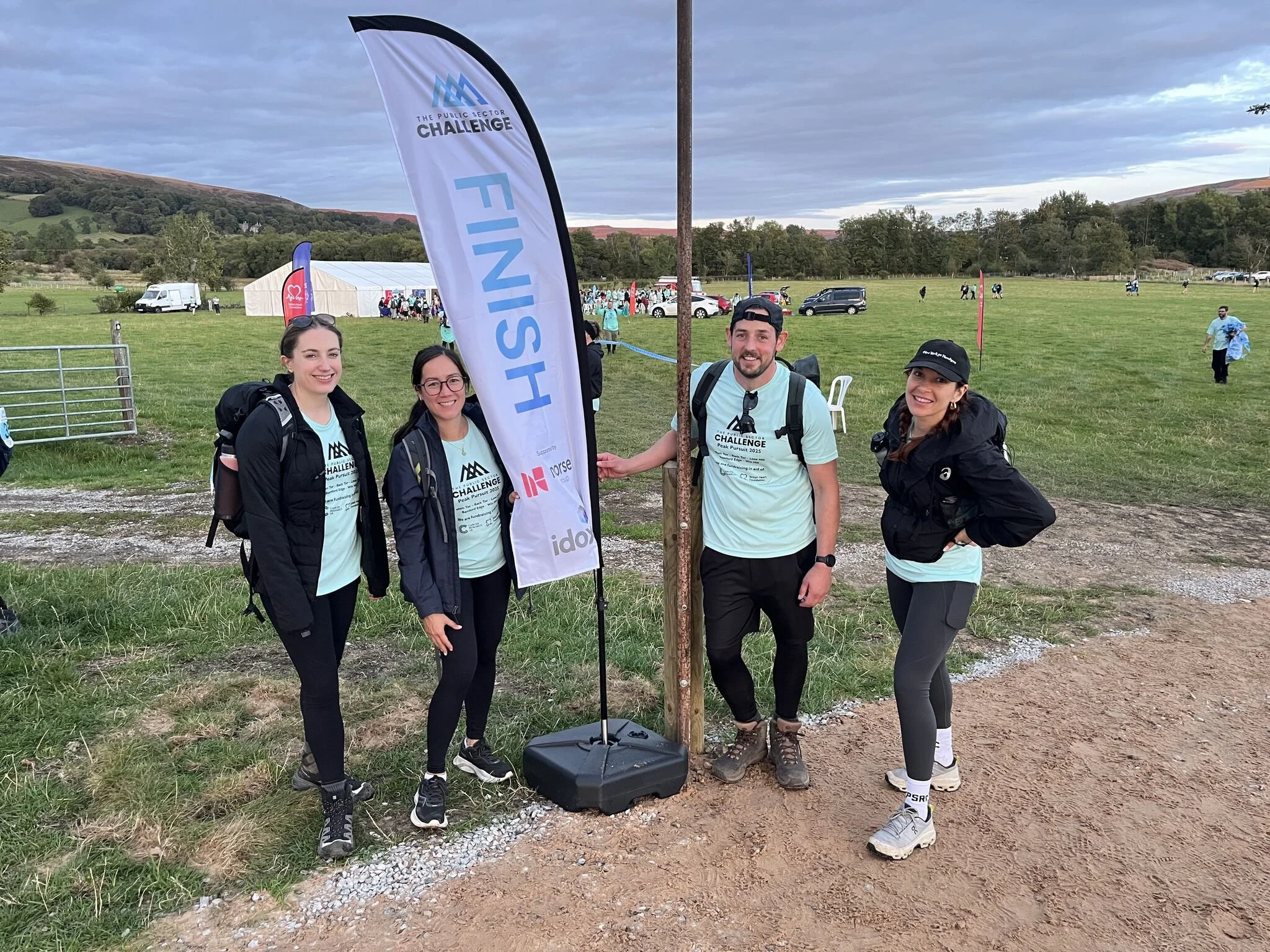 Newtrality team at the Peak Pursuit 2025 Public Sector Challenge finish line in the Peak District, celebrating teamwork and resilience.