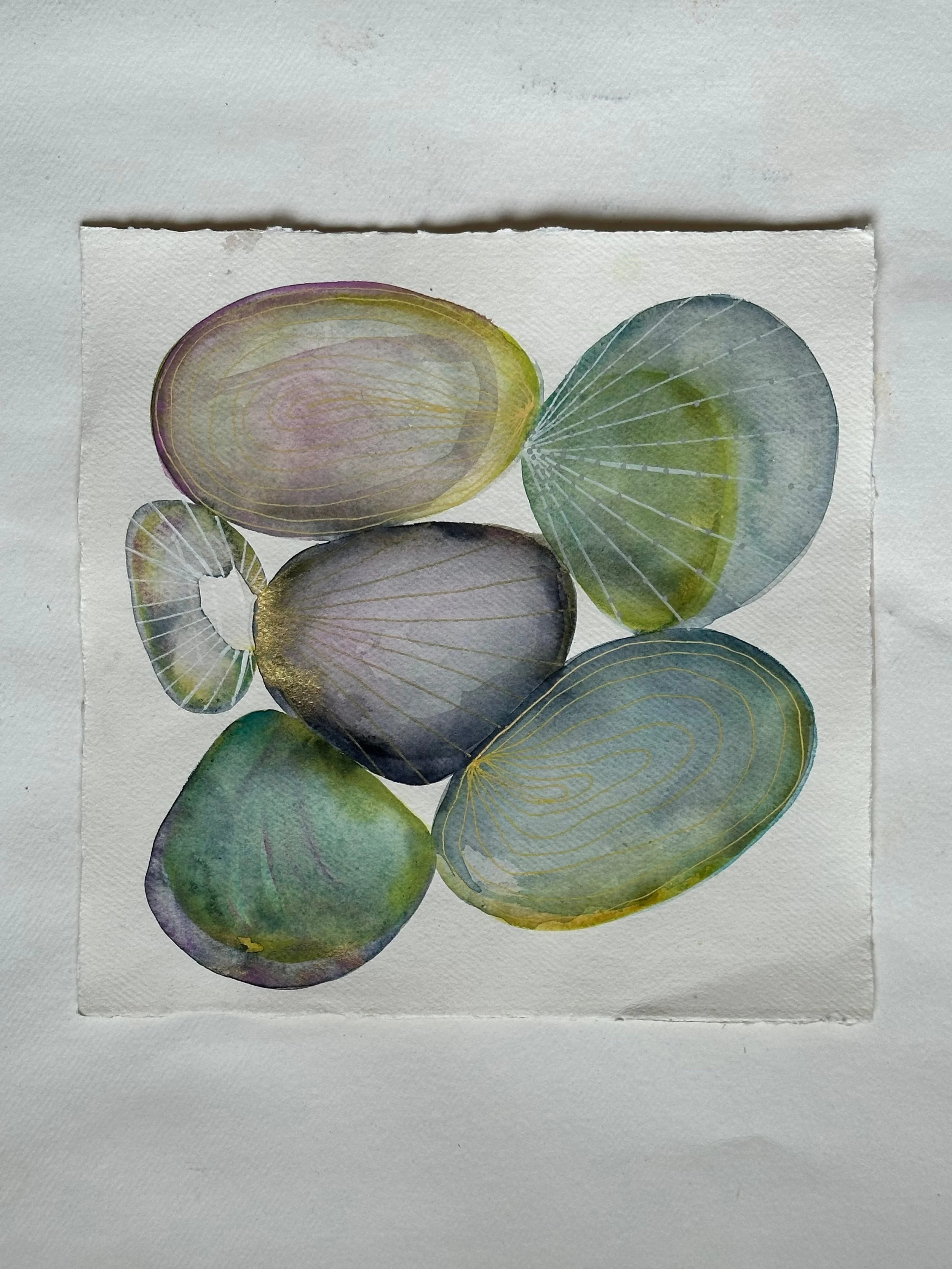 Abstract watercolor painting featuring overlapping, semi-transparent oval shapes in various shades of blue, green, and purple on textured paper.
