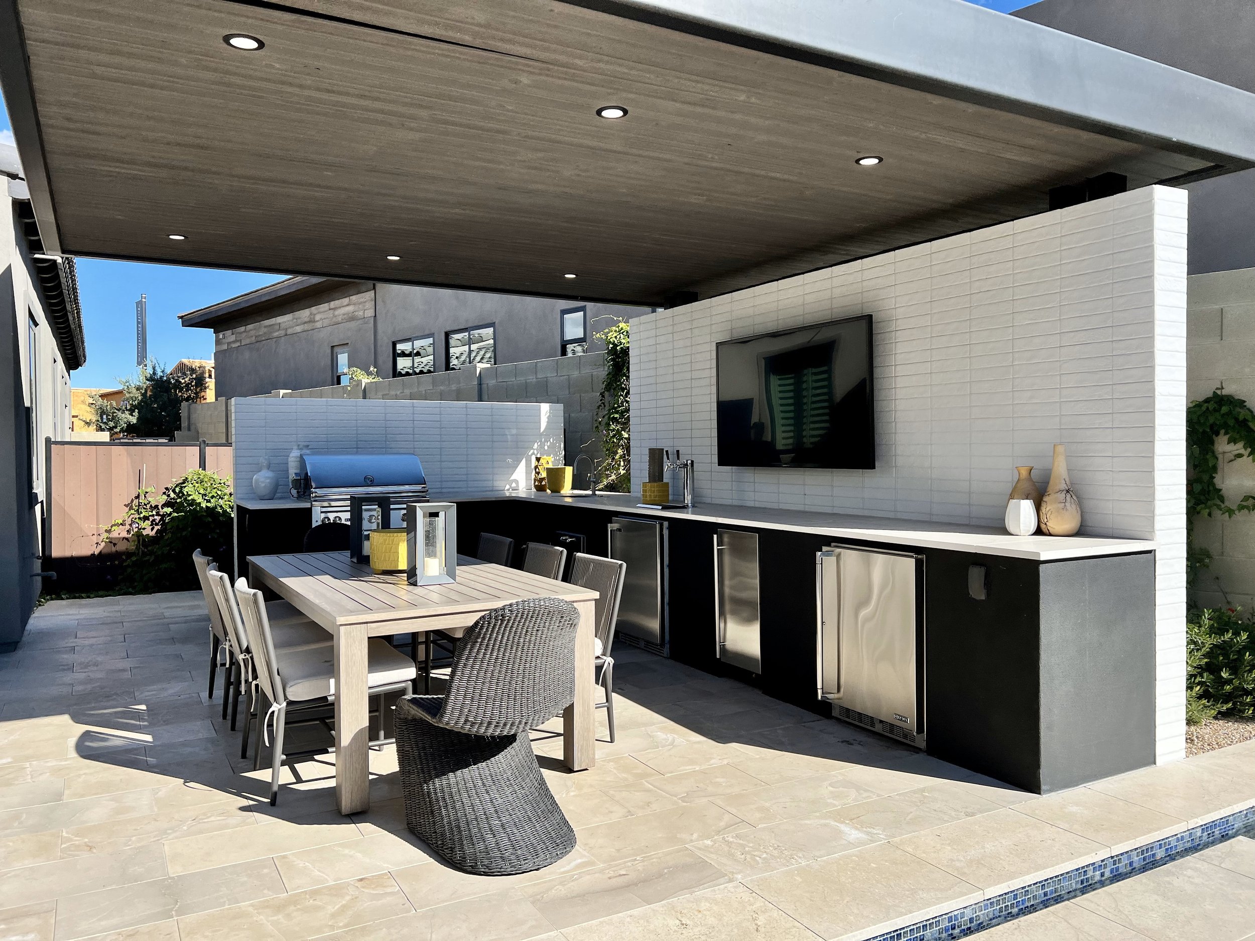 outdoor dining entertainment white textured tv wall ramada dining table wet bar beer taps