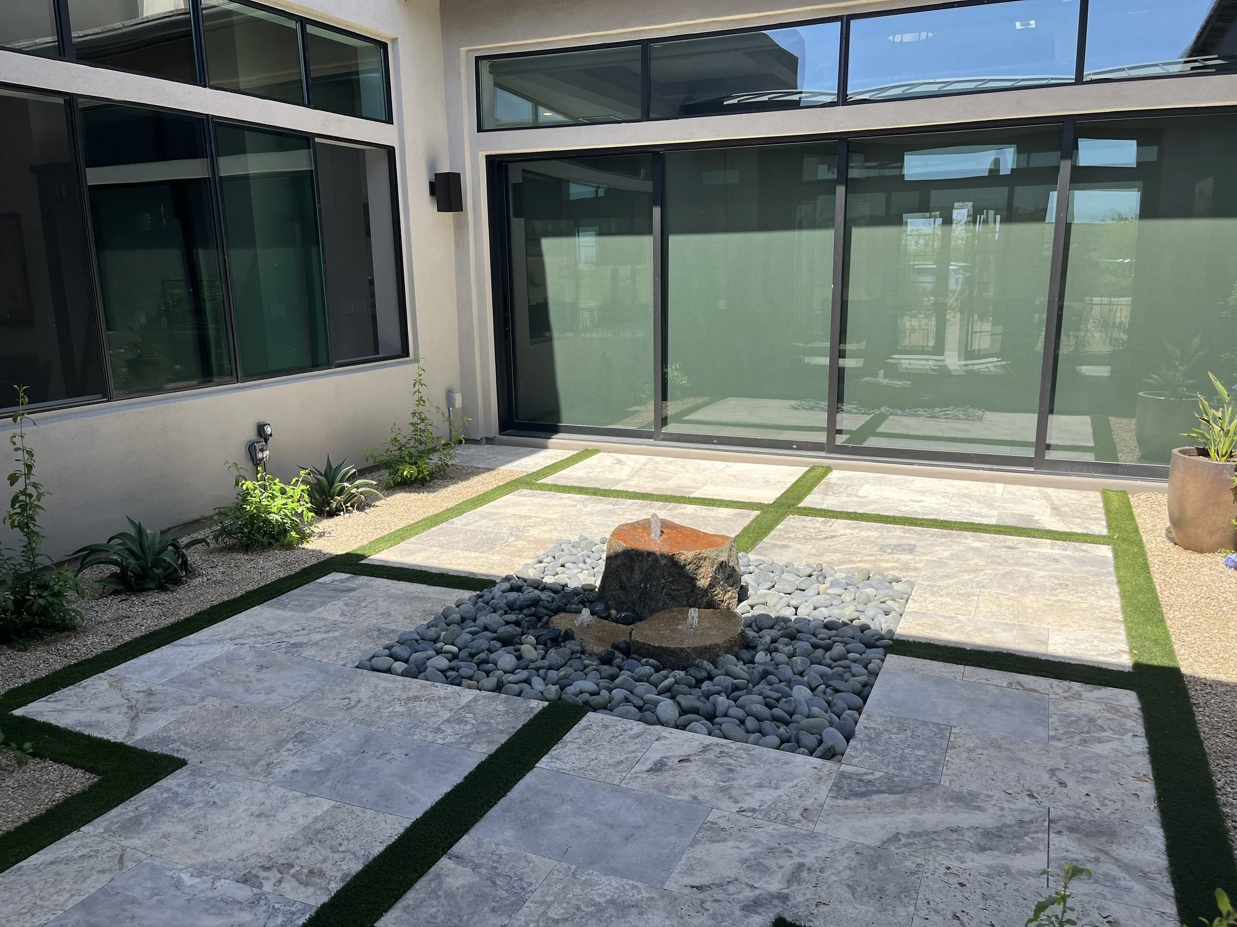 courtyard water feature bubbling rock pebbles travertine