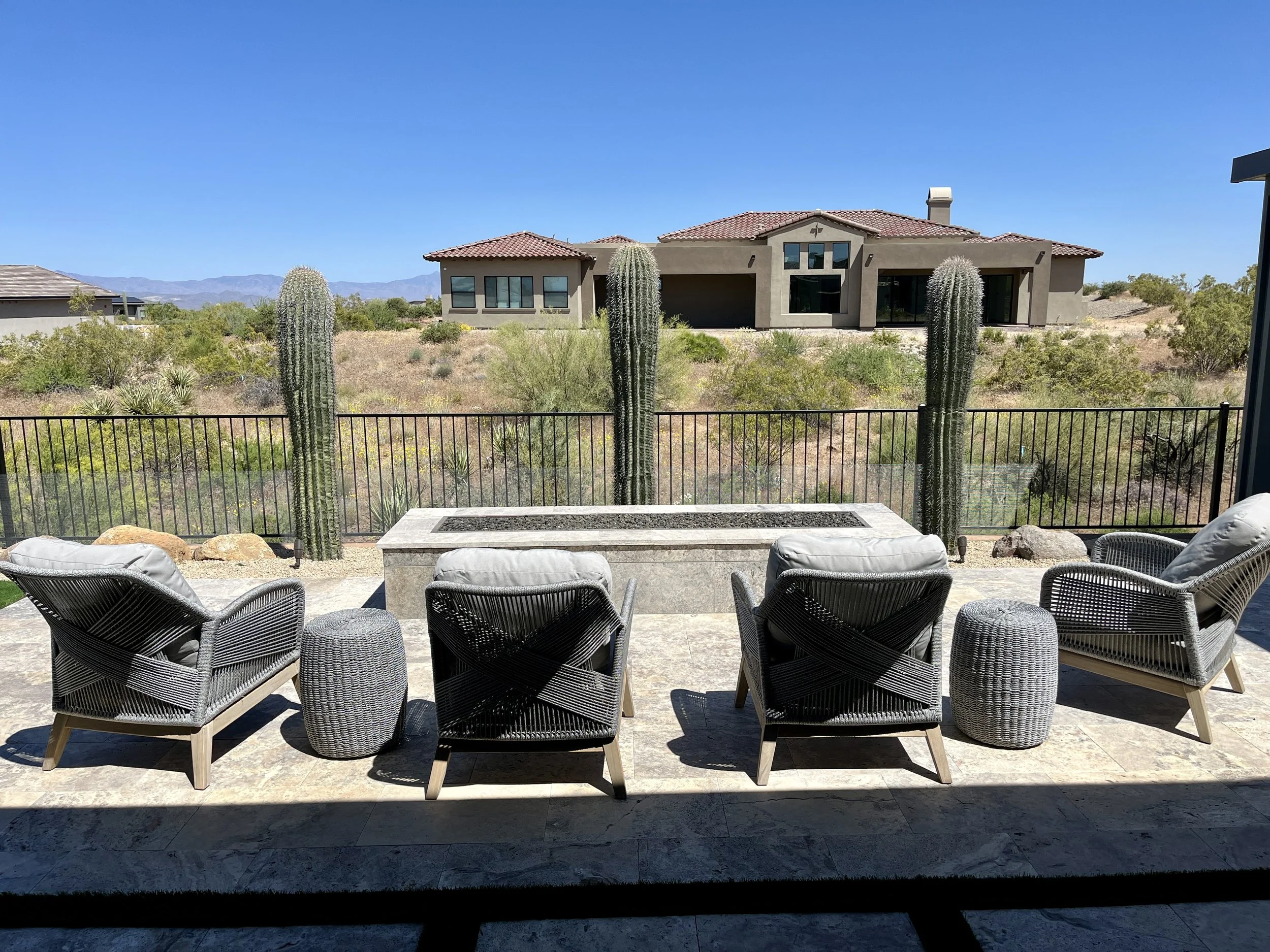 long rectangle travertine firepit seating area mountainside saguaros