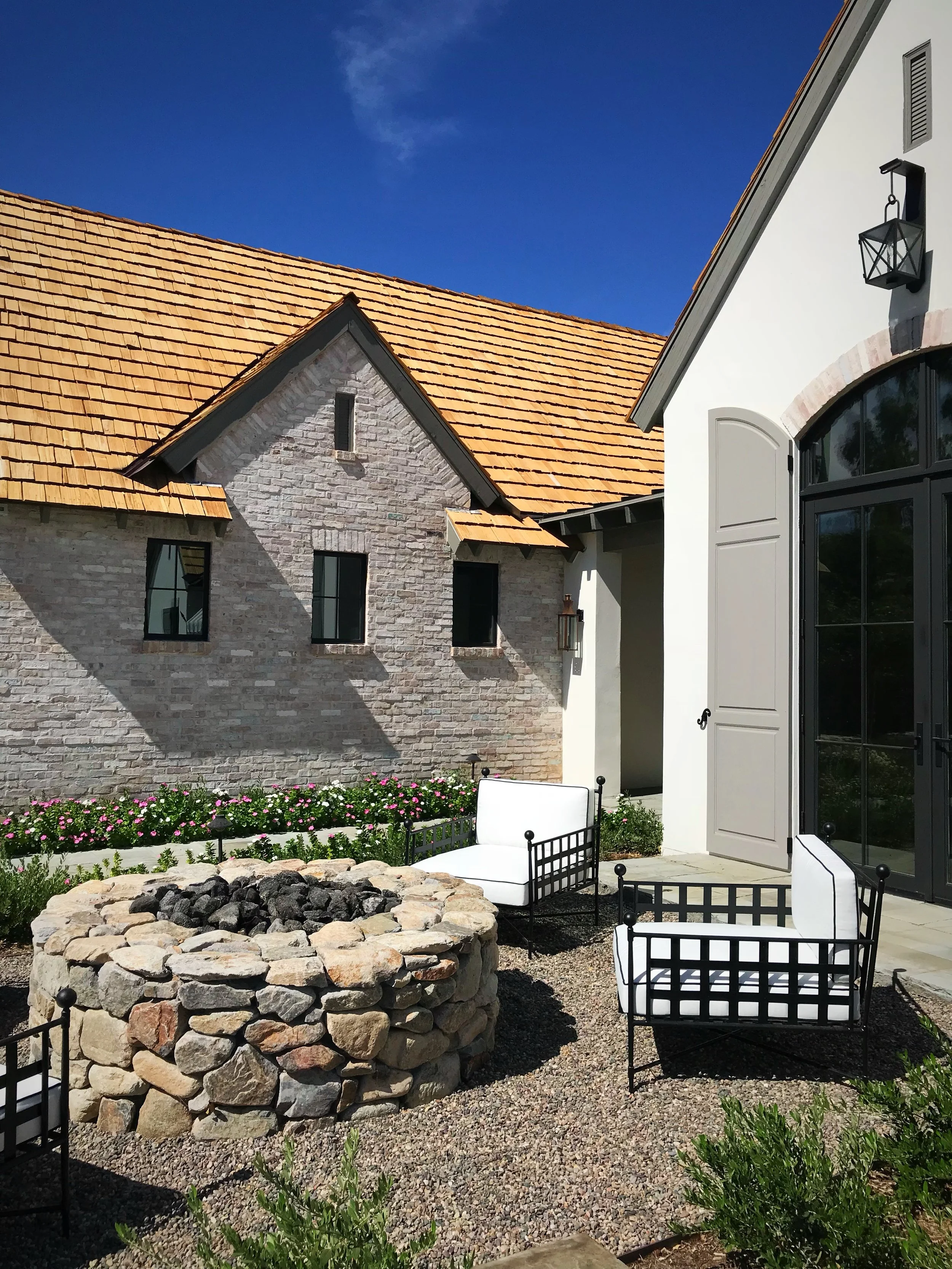 round fire pit fire feature rock boulder courtyard