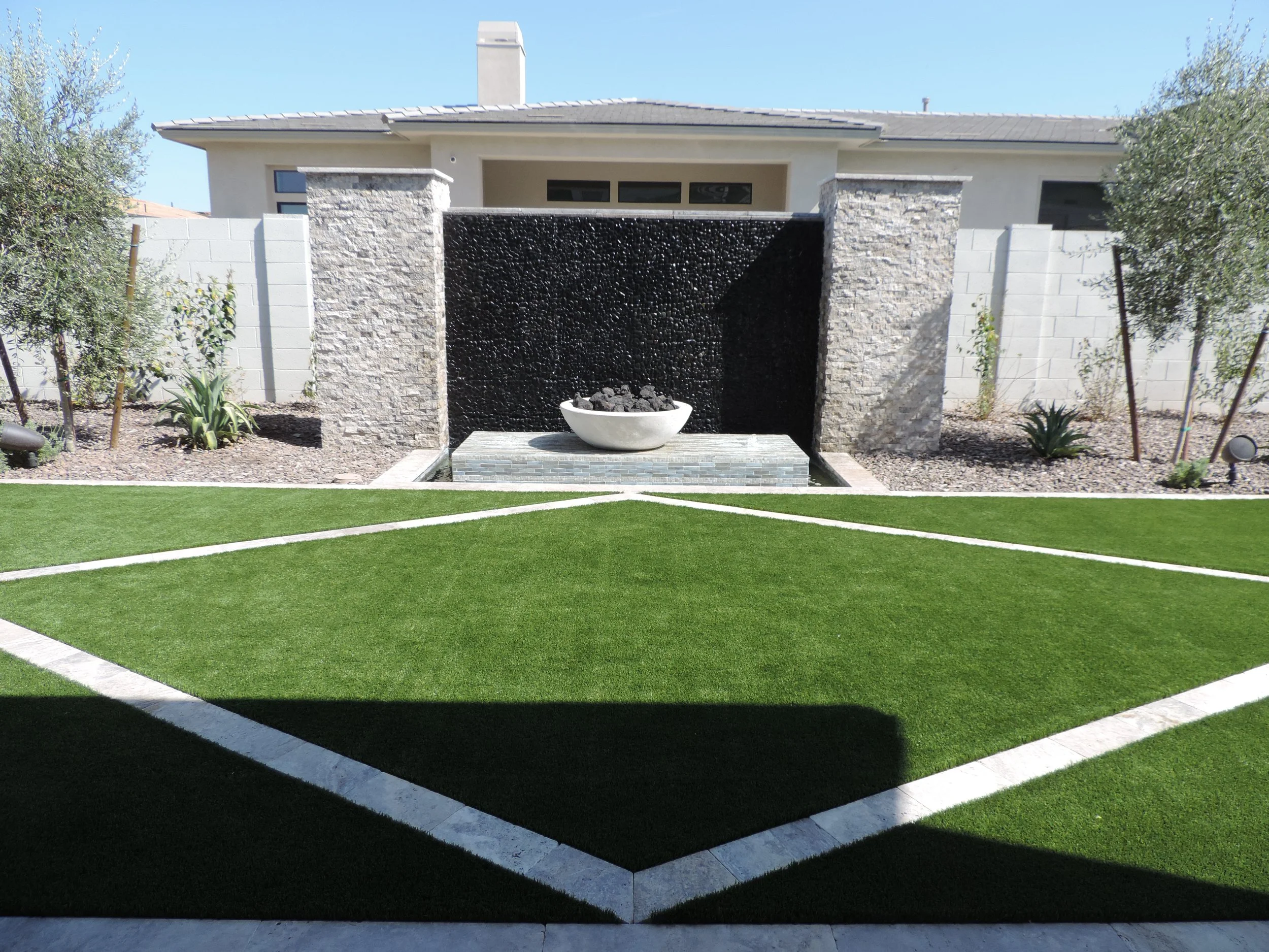 black pebble stone water feature wall fire bowl