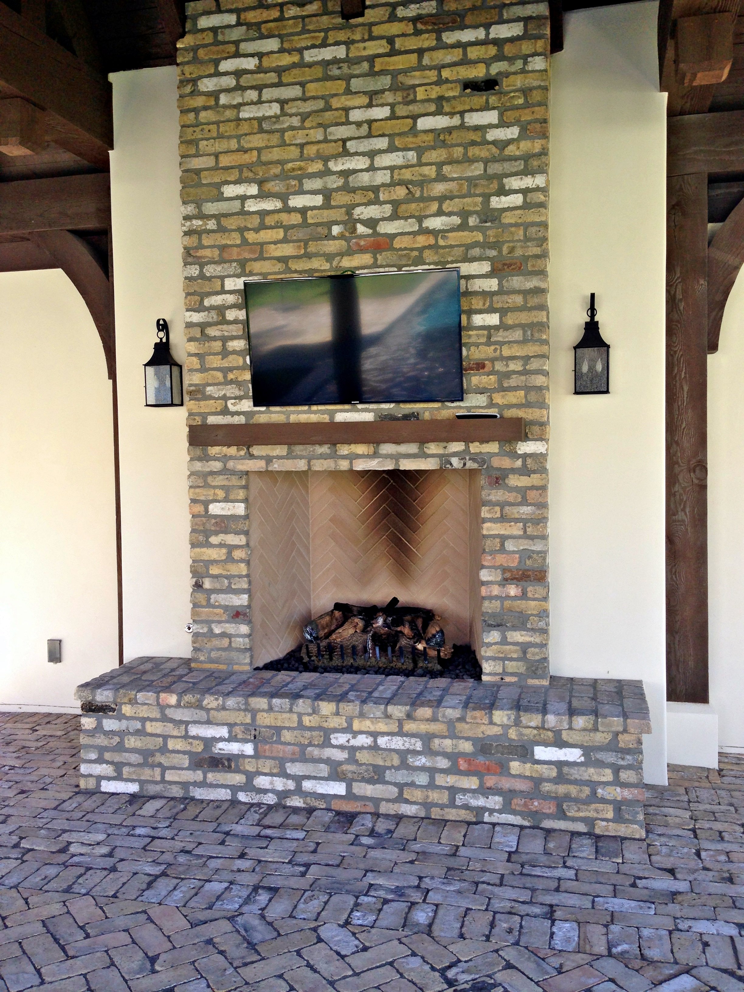 outdoor fireplace below tv cozy classic