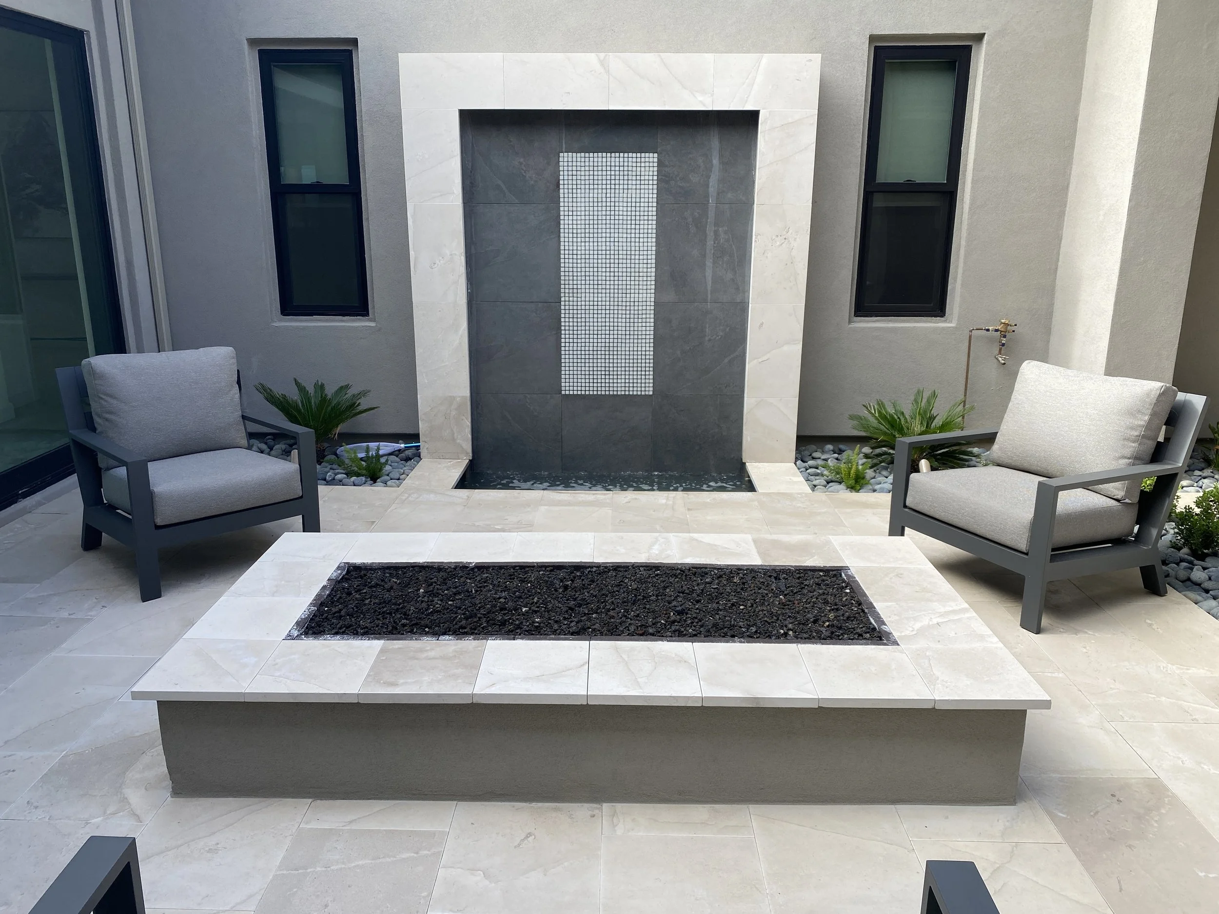 rectangle fire pit lava rock travertine water feature sitting area