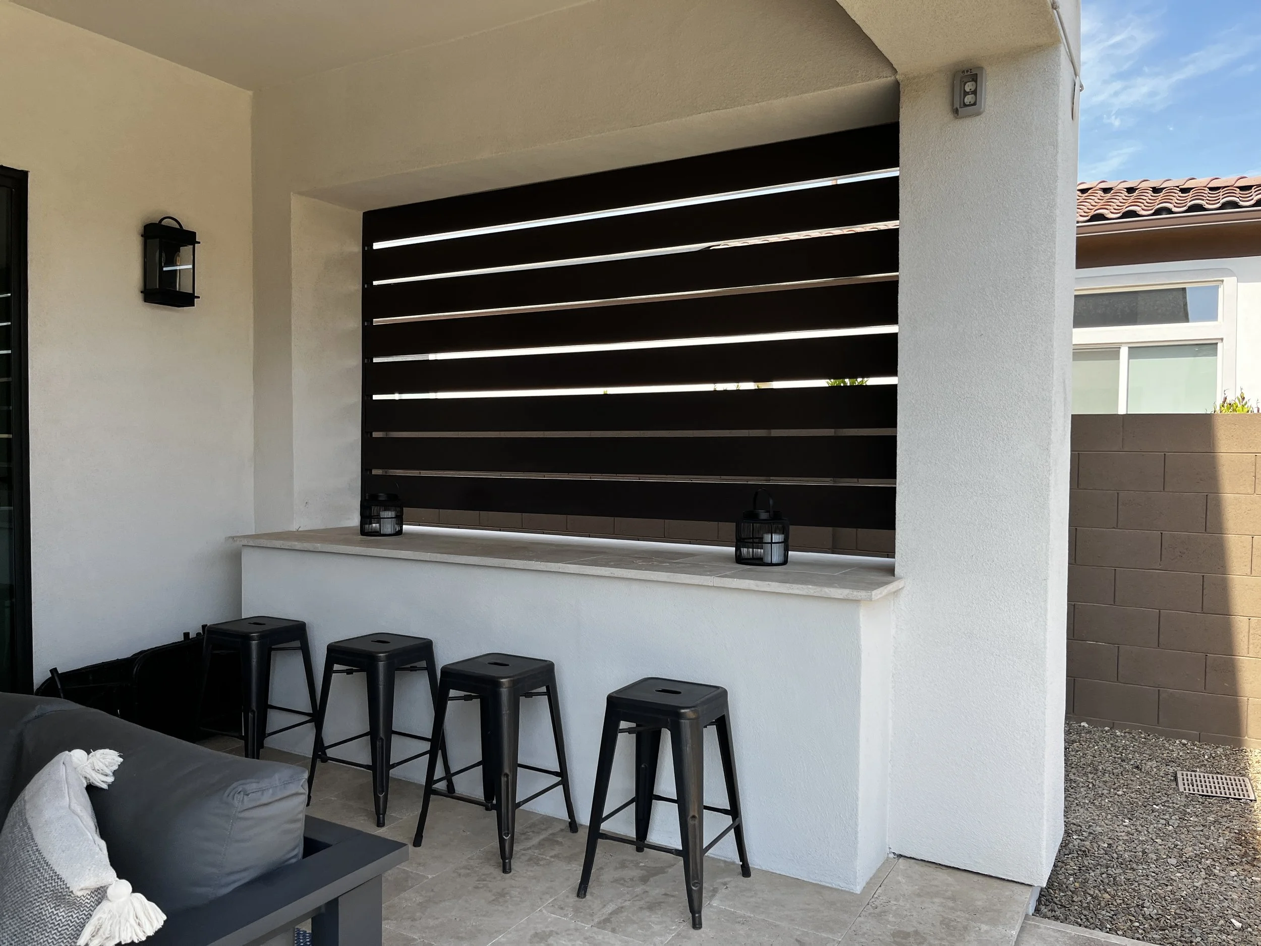 outdoor dining area bar top barstools decorative wall privacy