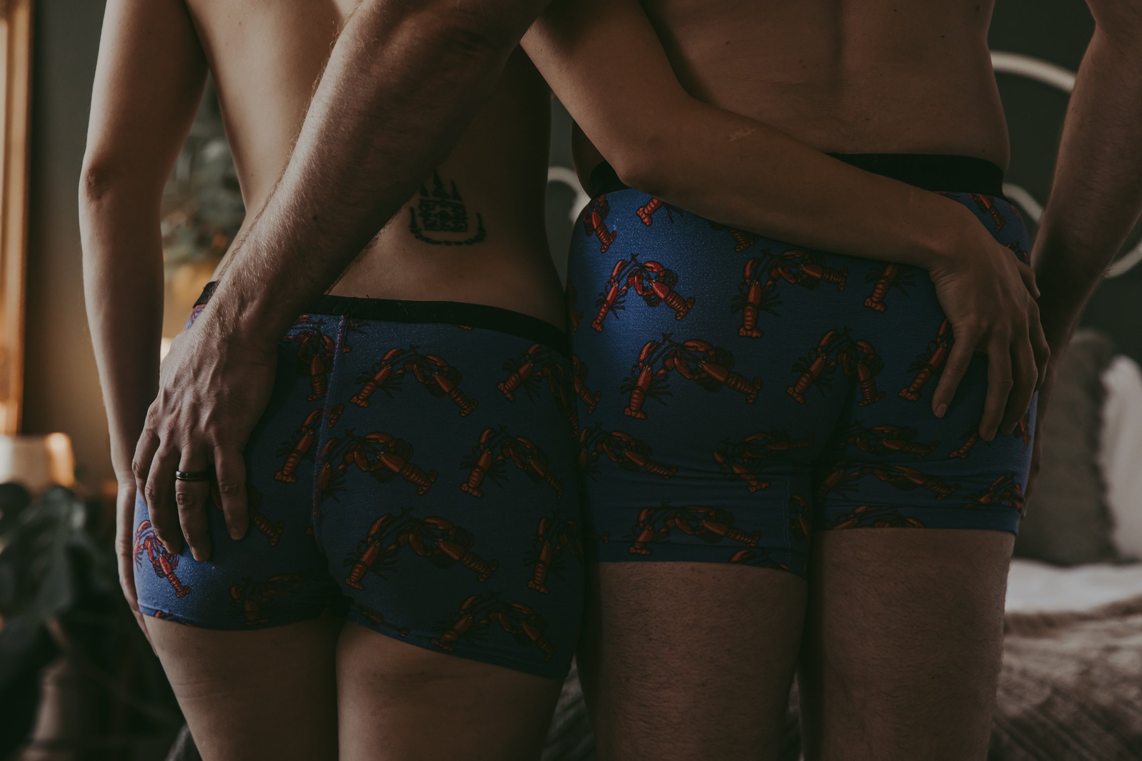 a man and woman standing and posing during a couples boudoir session in Edmonton