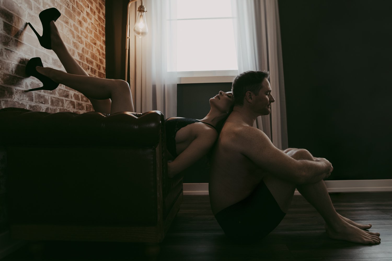 A man and woman posing during a couples boudoir photography session in Edmonton.