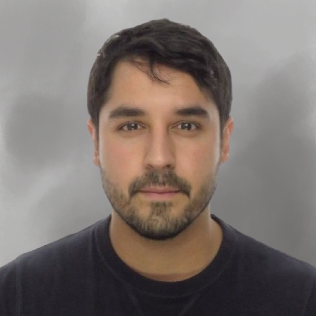 Portrait of a young man with dark hair, beard, and mustache, wearing a black shirt, standing against a gray background.