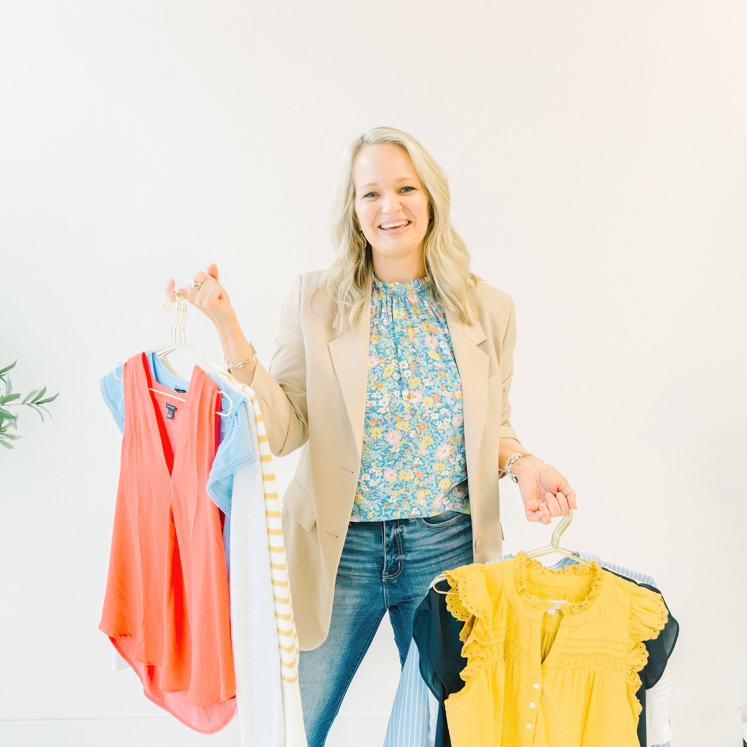 San Antonio personal wardrobe stylist Laura Longmire holding women's clothes on hangers